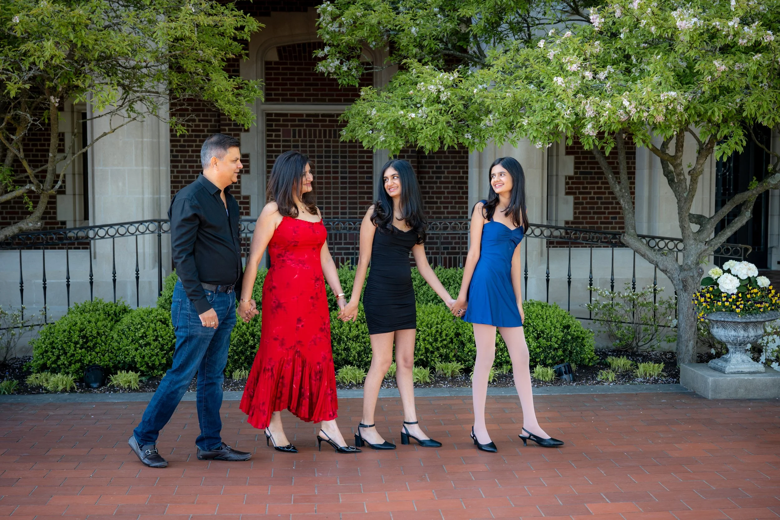 family walking and laughing. parents and daughters