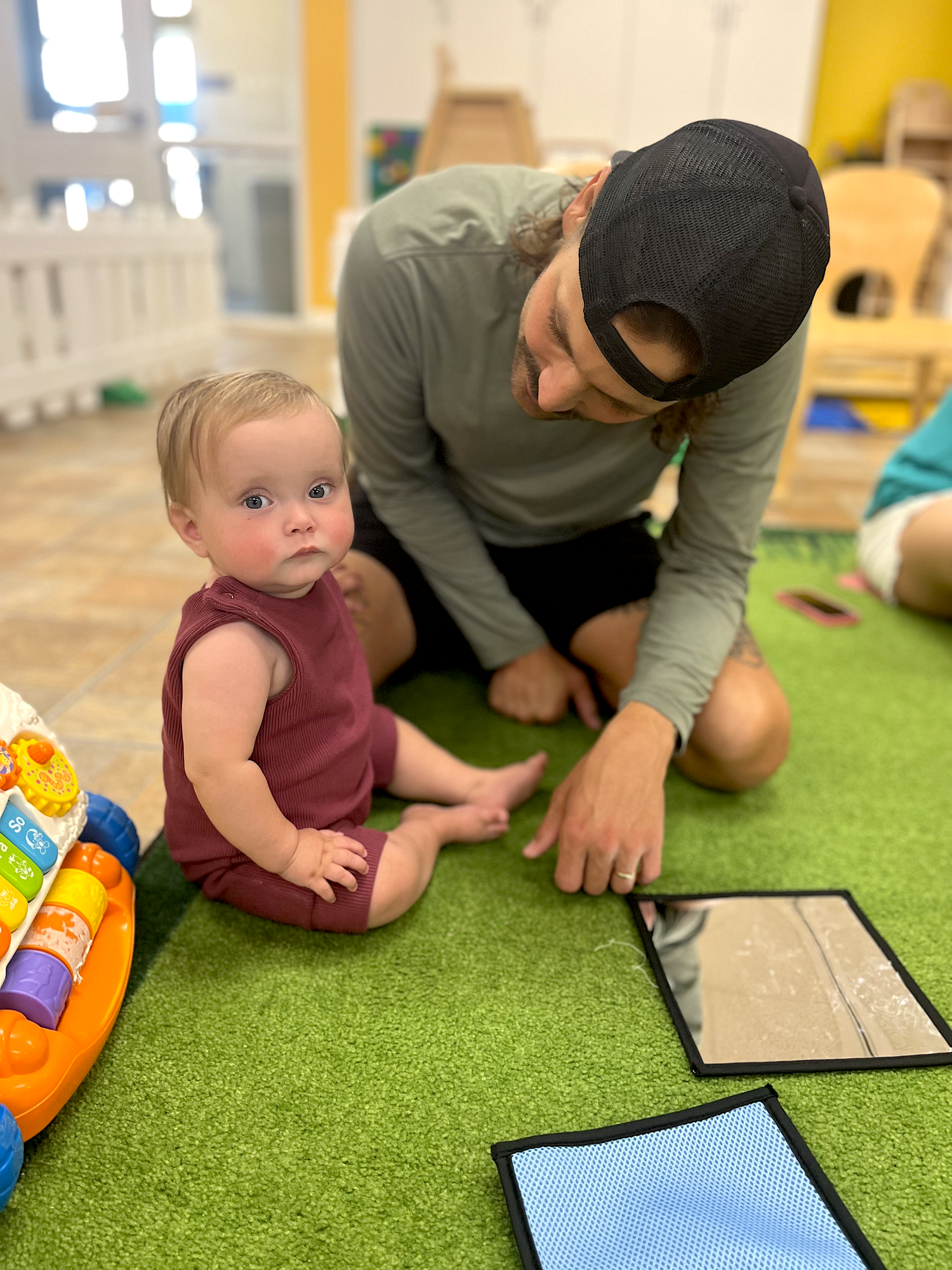 An ECLC caregiver engaging with a baby