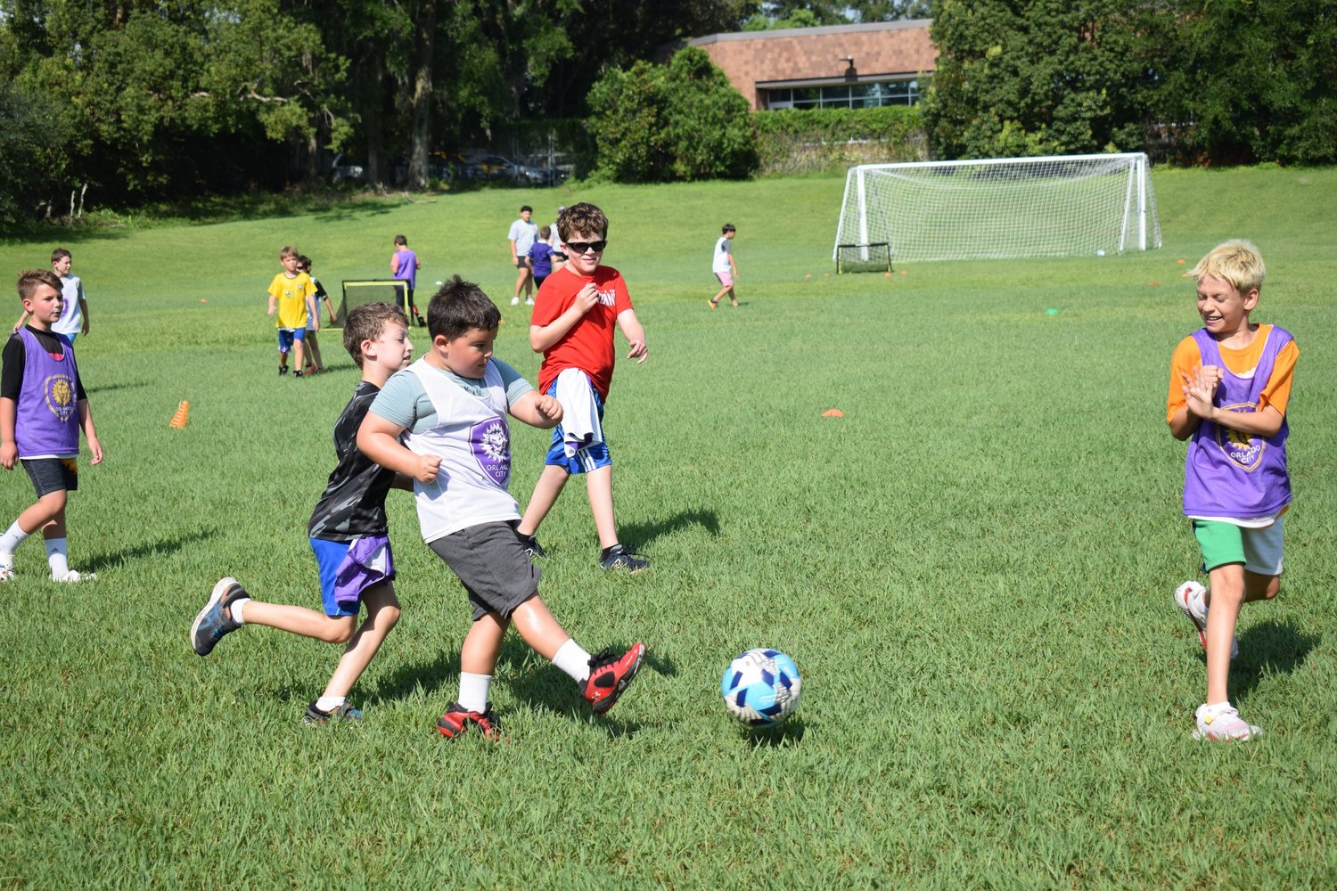 Children playing soccer on the field at Shalom Orlando