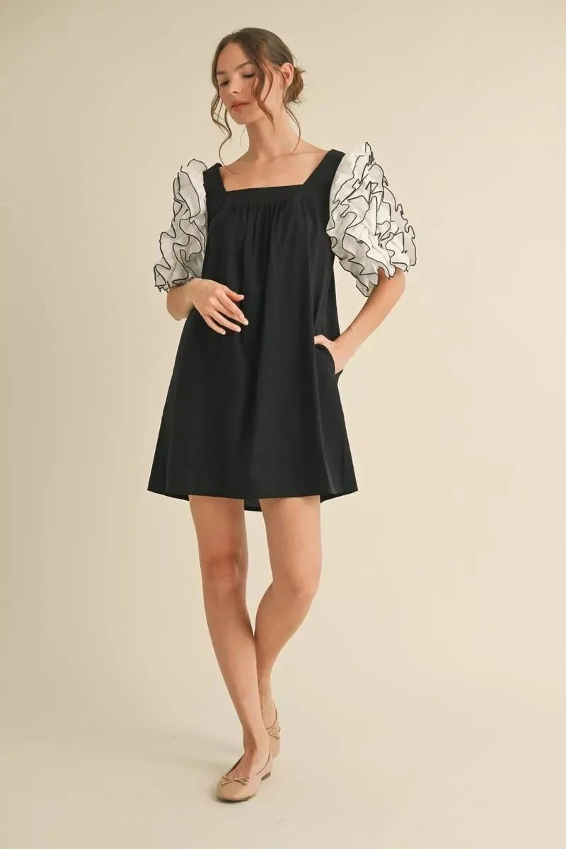 Elegant Black Dress with White Accent Sleeves