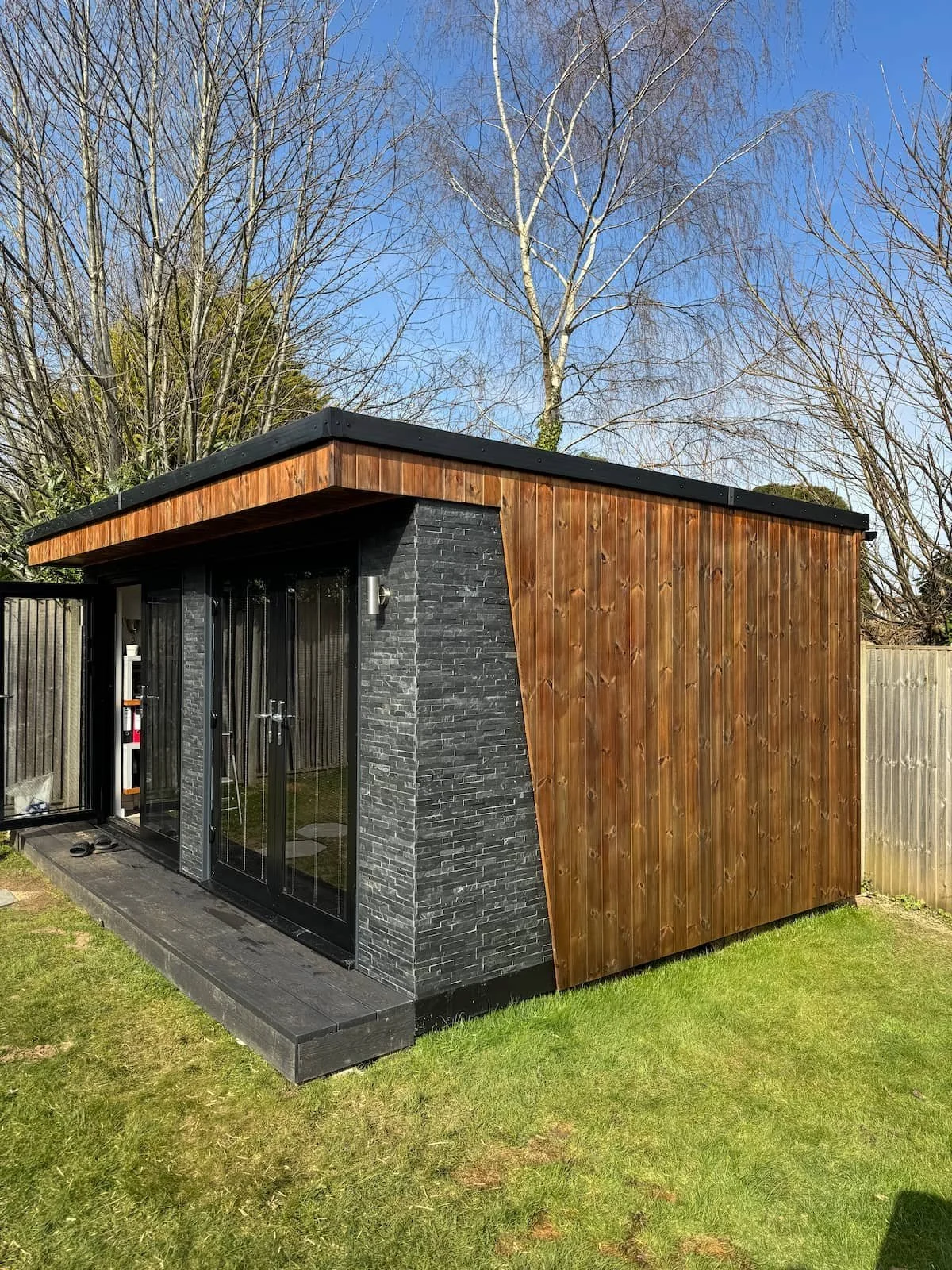 Freshly treated timber cladding on the garden office.