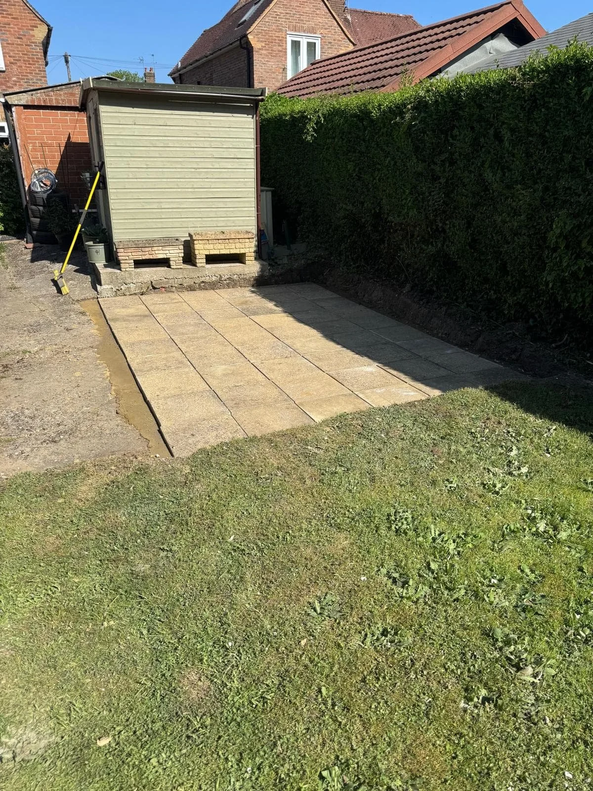 Reused slabs carefully laid out to form the new patio layout, giving existing materials a second life.