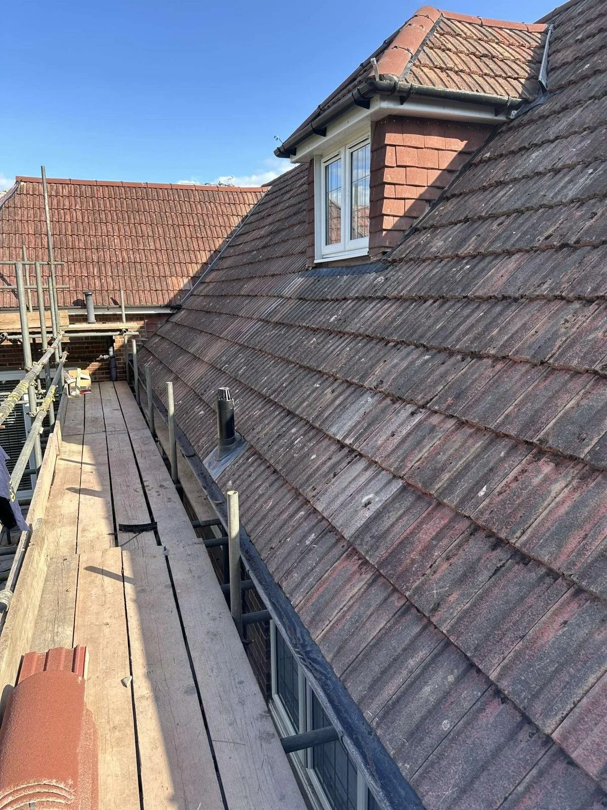 Original tiles removed, cleaned and prepared for reinstallation during the re-roof.