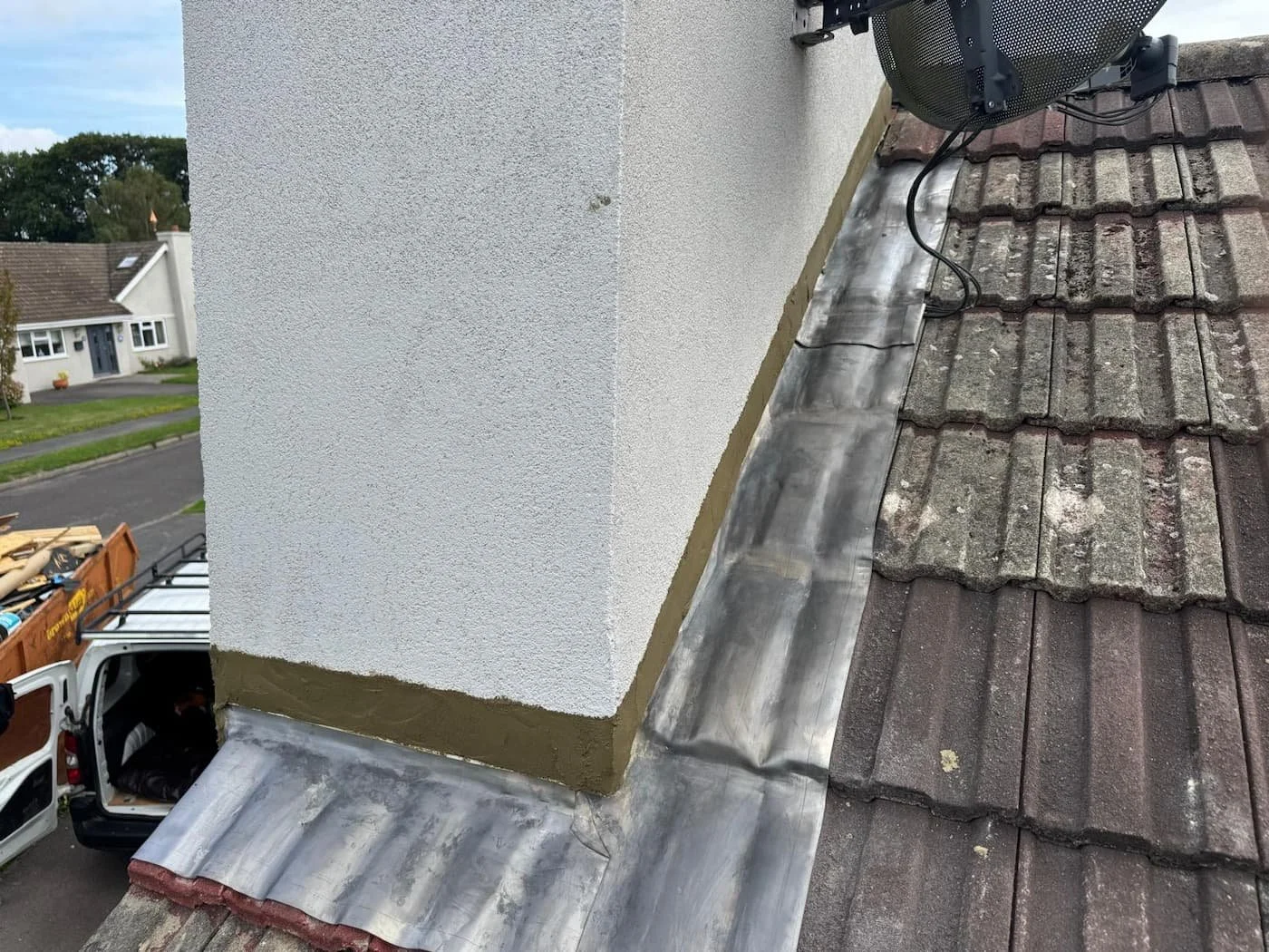 Chimney flashing completed, neatly pointed and sealed to prevent water ingress.