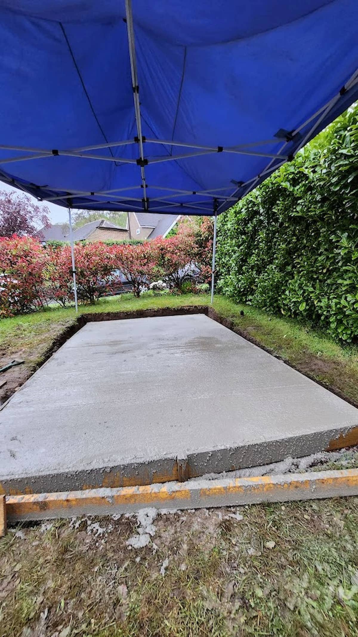 Fresh concrete poured and levelled to form a strong, reinforced shed foundation.