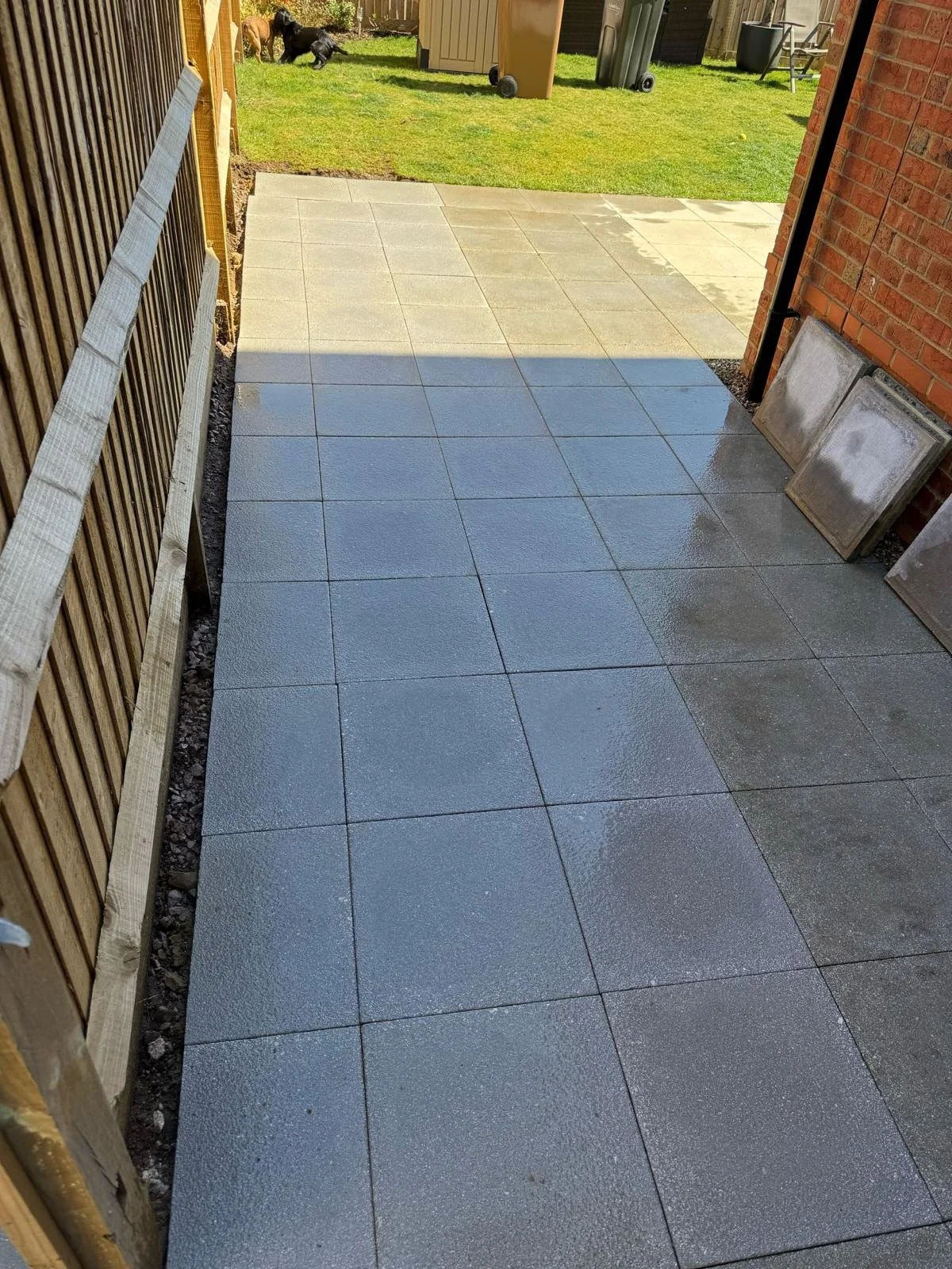 Completed patio extension matched seamlessly to the existing paving for a larger outdoor space.