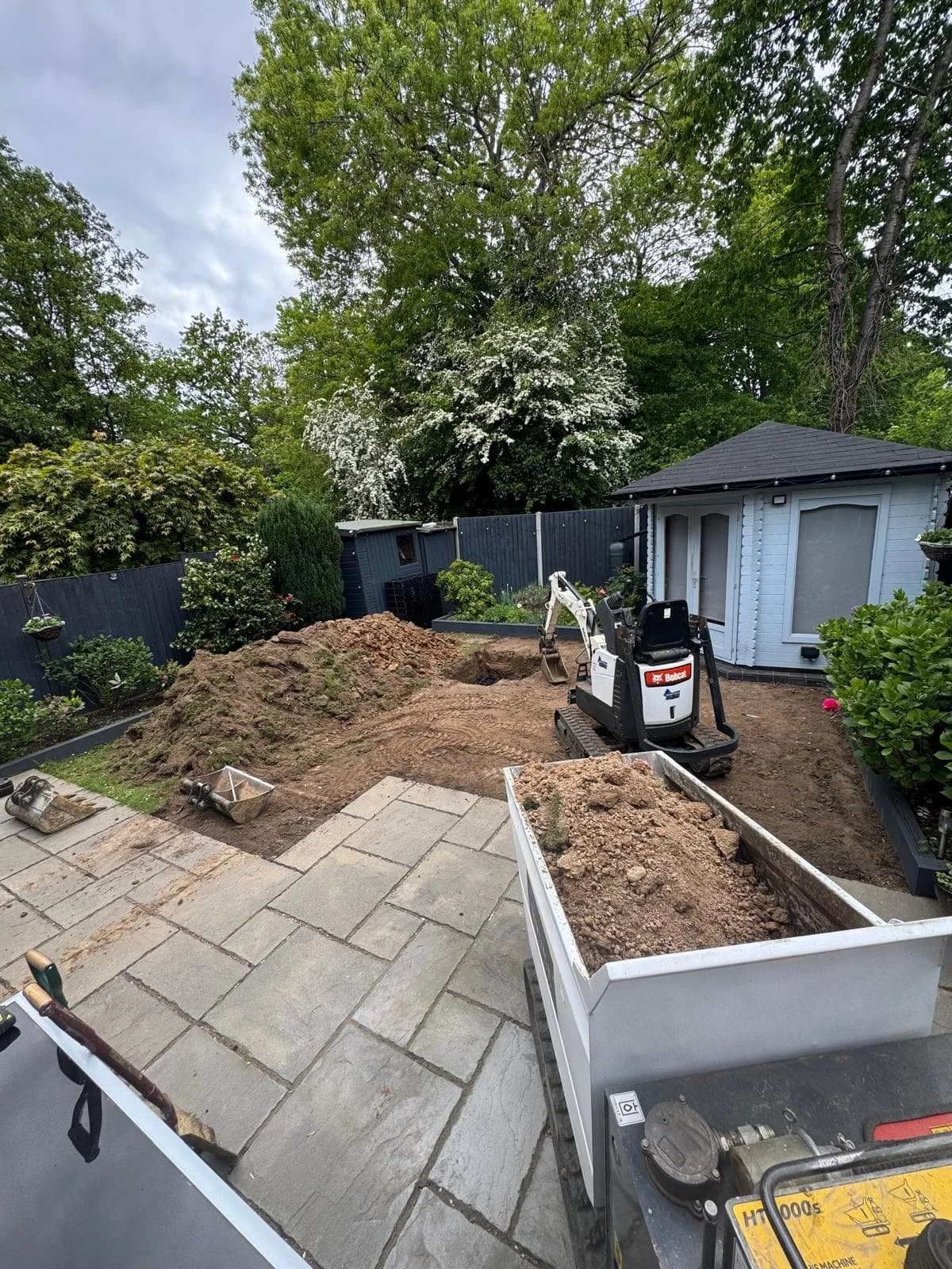 Excavation shaping the soakaway chamber and drainage layout.