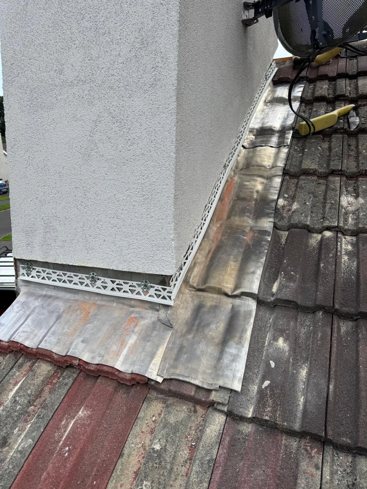 New lead flashing installed around the chimney for a long-lasting seal.