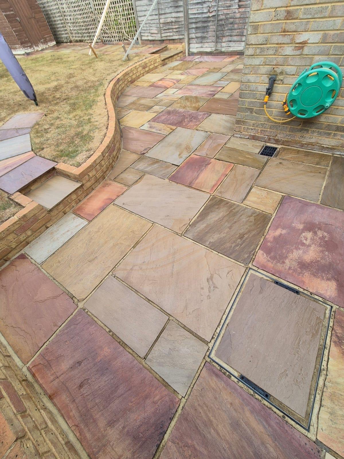 Fully cleaned and sealed sandstone patio with a smooth finish and restored natural tones.
