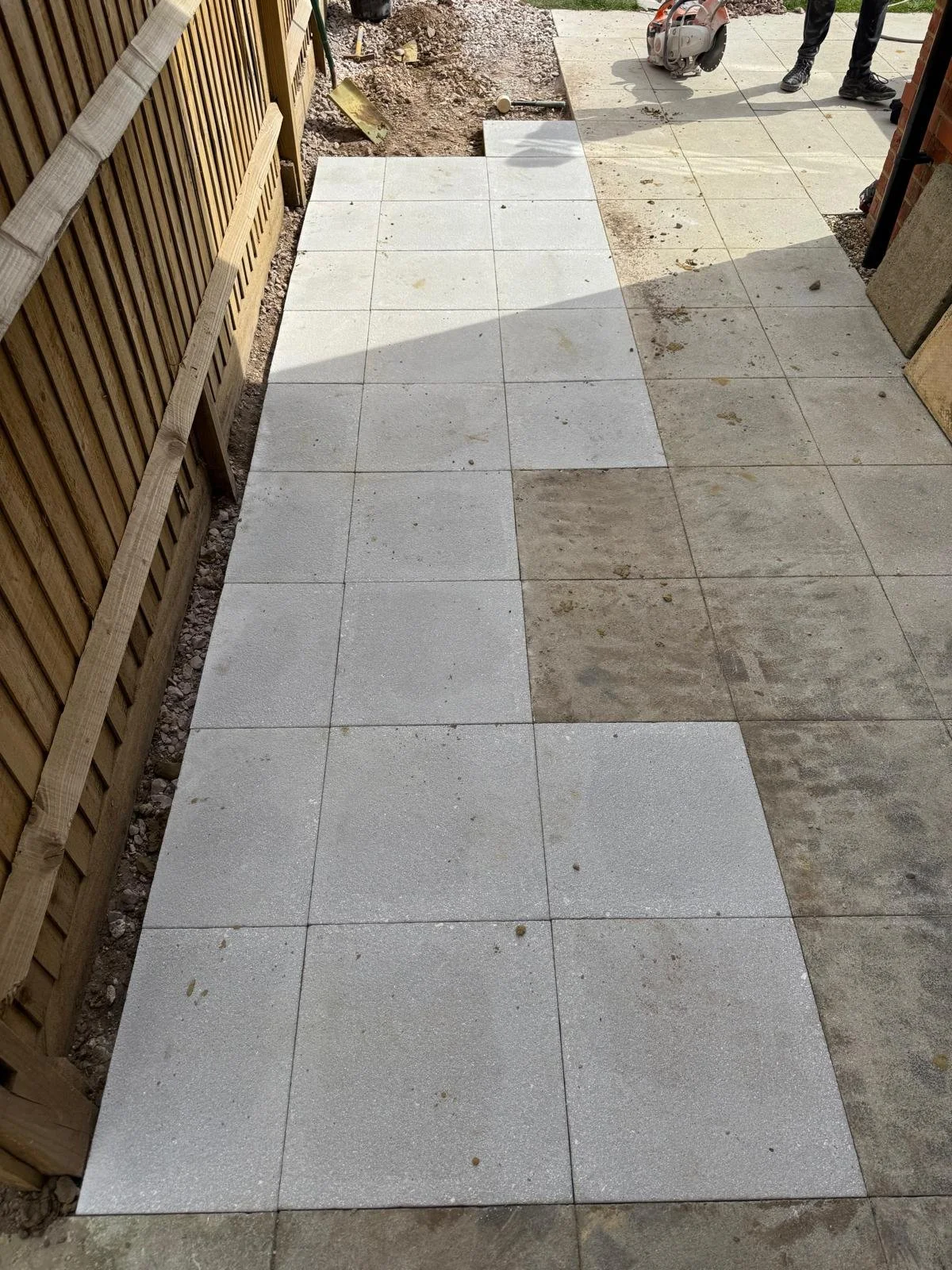 Final view of the extended patio with crisp joint lines and a clean, unified finish.