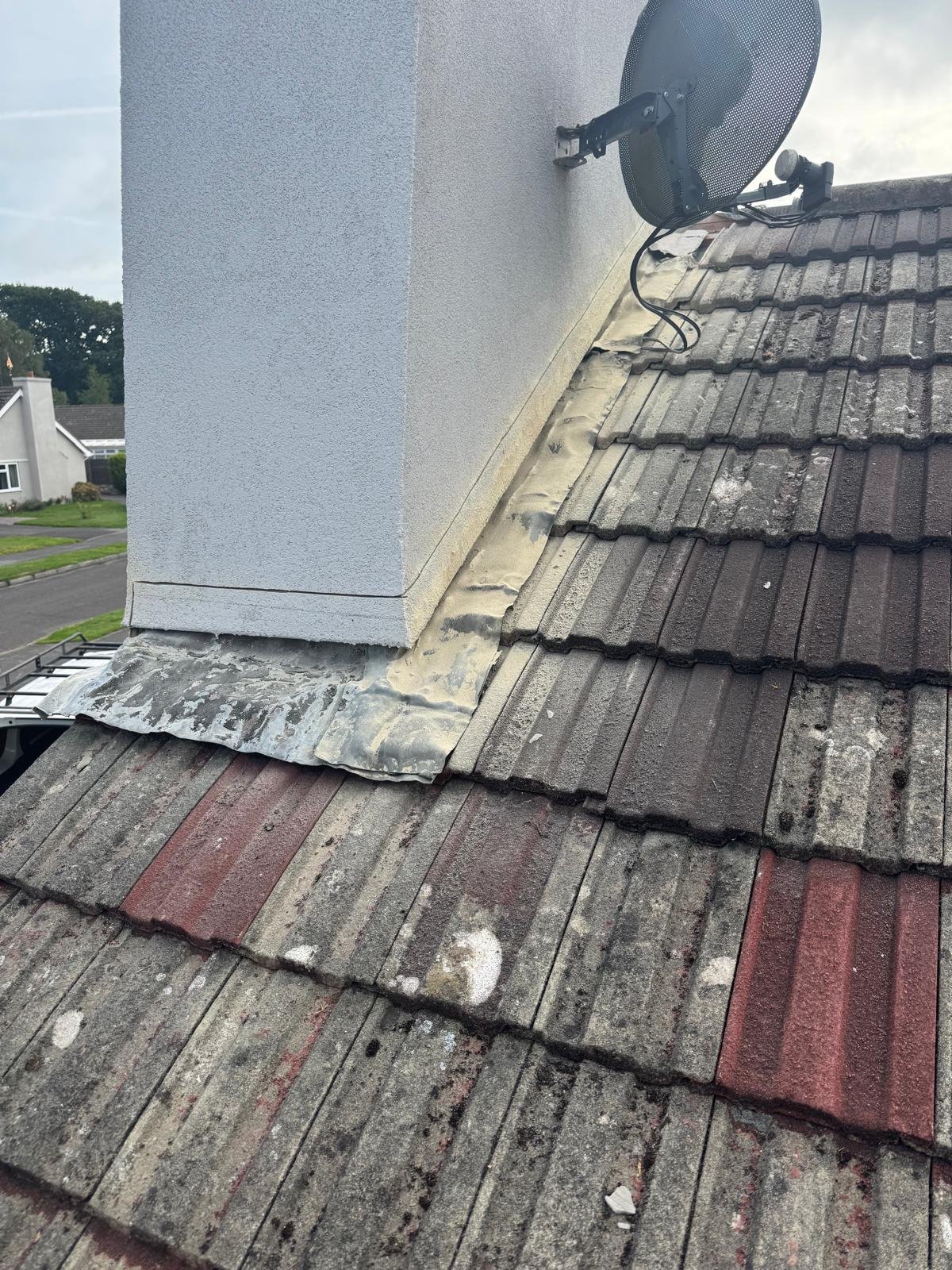 Old cracked chimney flashing that had been allowing water to track behind the tiles.