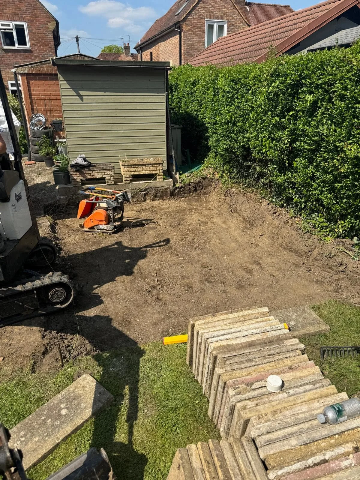 Patio area fully dug out and shaped, ready for the new sub-base installation.