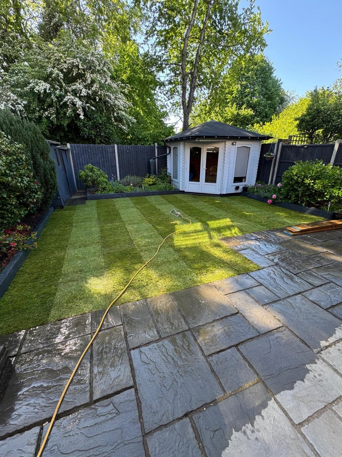 Completed lawn showing a clean, striped finish after soakaway and turfing works.