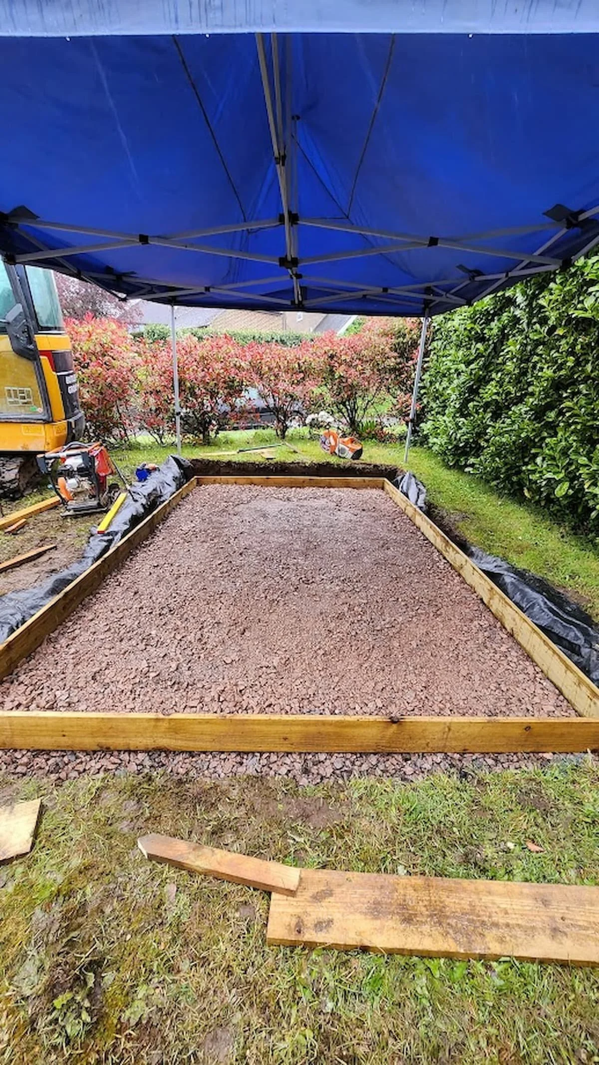 Reinforcing mesh installed over the compacted sub-base with shuttering set around the edges.