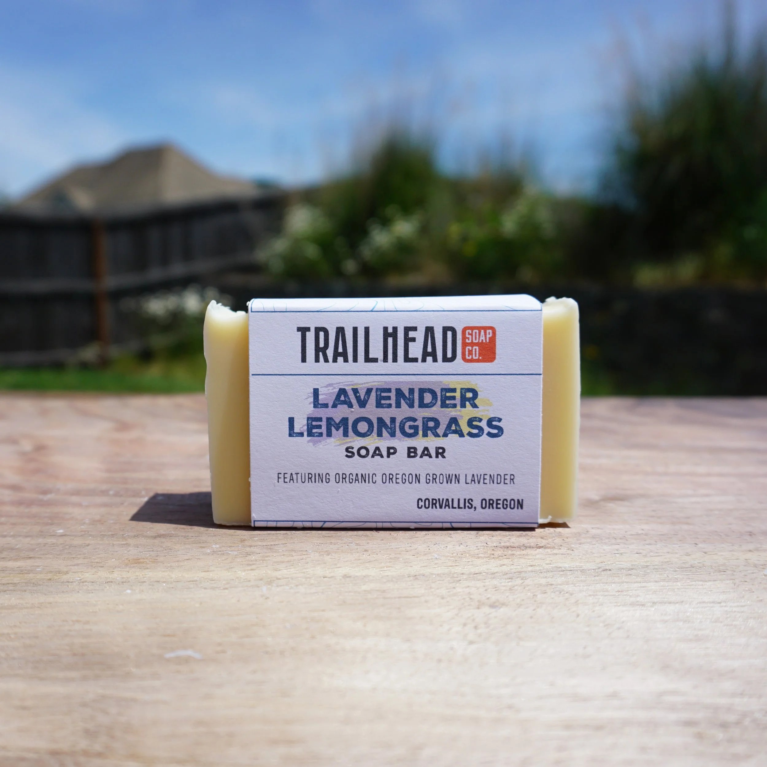 Lavender lemongrass soap bar outdoors on wooden surface.