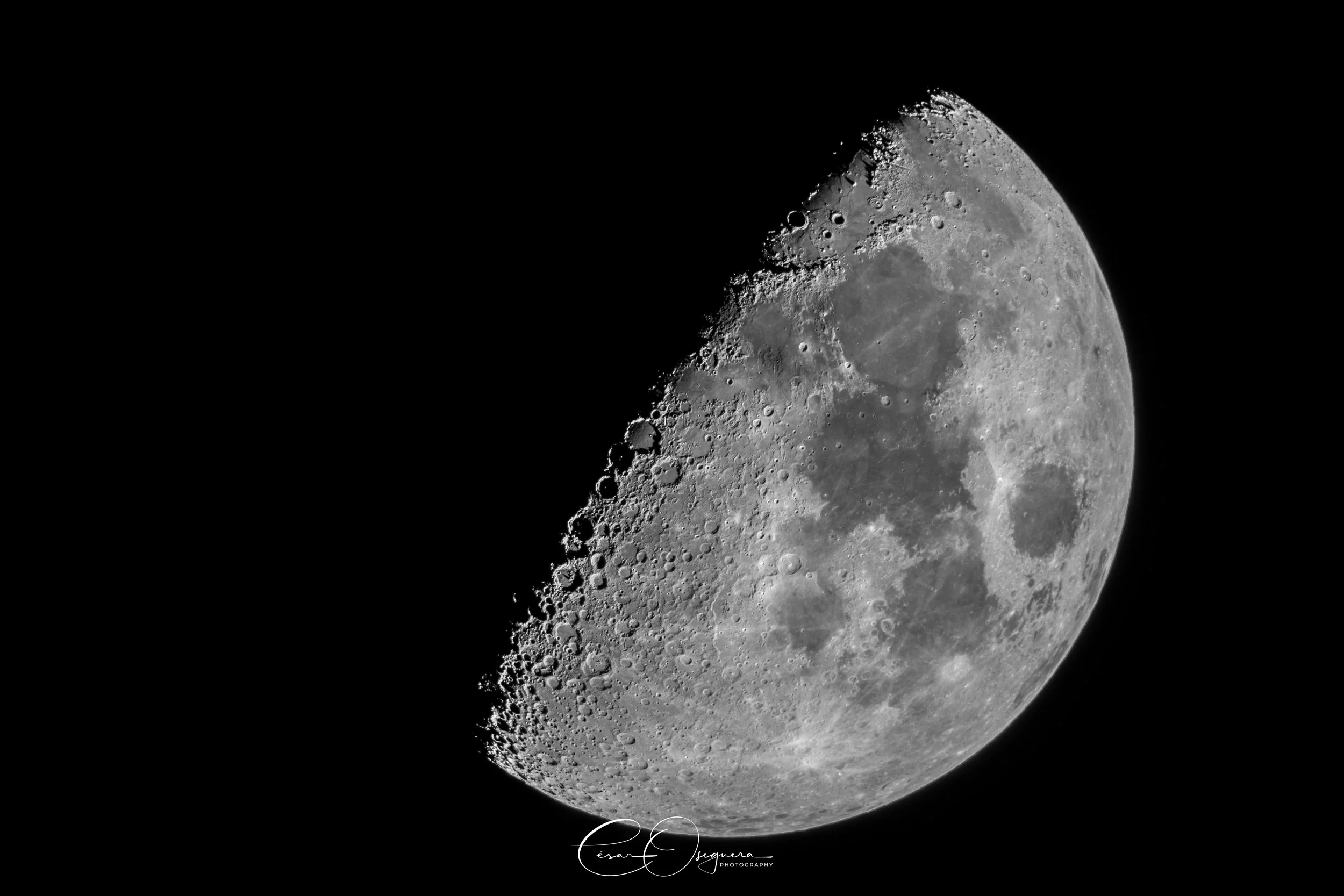 Close-up view of the moon showing detailed craters and surface features, set against a black background.