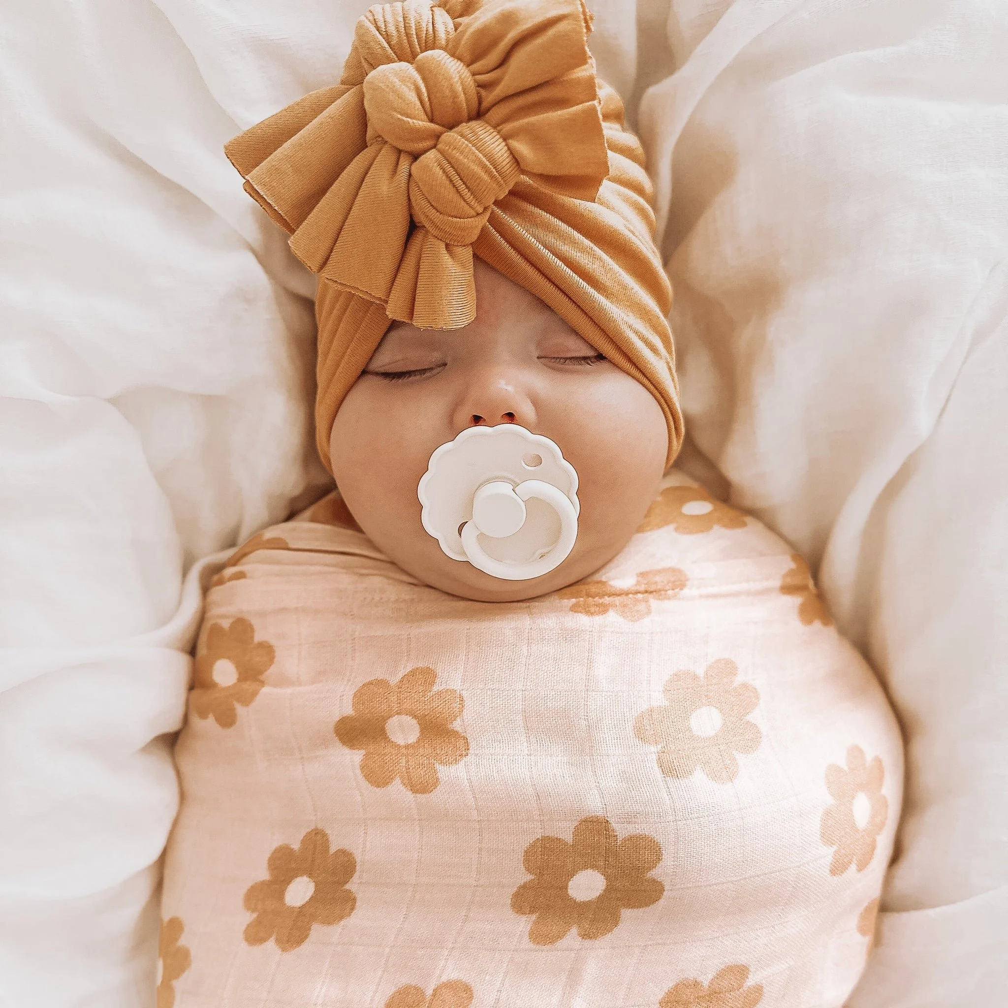 MWRAP18-DaisyChainSwaddle-LikedByLeo-2-square_29c12b3d-f978-4799-a767-41dc1f852414_2048x2048.jpeg