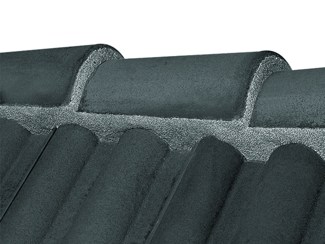 Gray Flexim Roof Mortar applied to clay roof tiles for weatherproof sealing