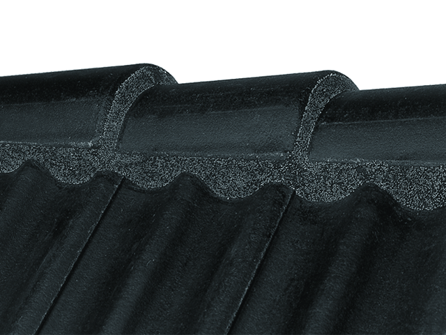 Black Flexim Roof Mortar applied to clay roof tiles for weatherproof sealing