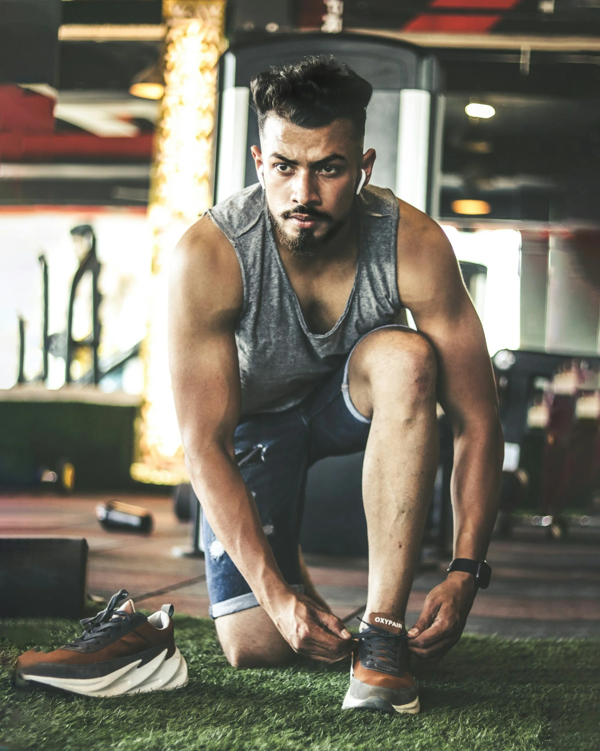 Modern house located on a hillside surrounded by grassy terrain and mountains in the background.