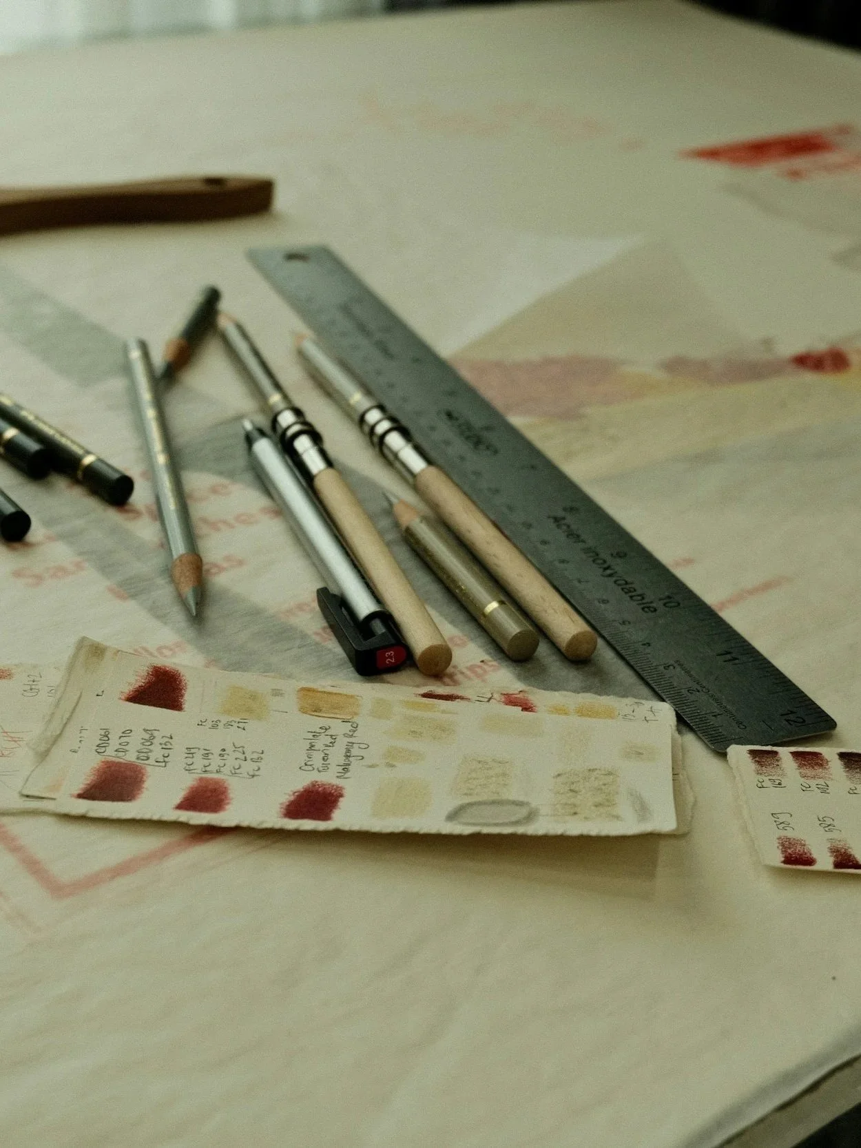 Ruler, pencils, and pens on the floor