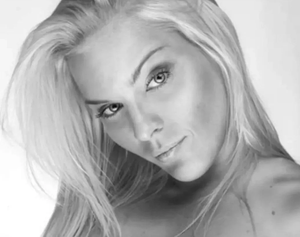 Black and white photo of a woman with long blonde hair looking at the camera.