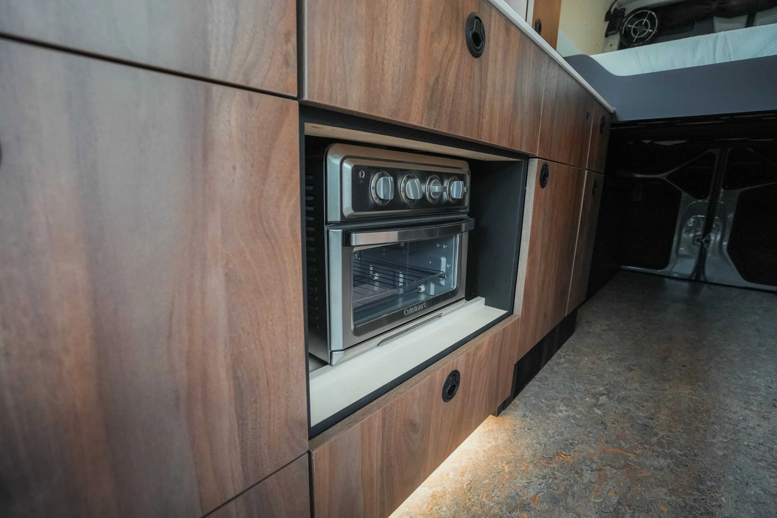Kitchen with wooden cabinets, built-in oven and stovetop, and a countertop.