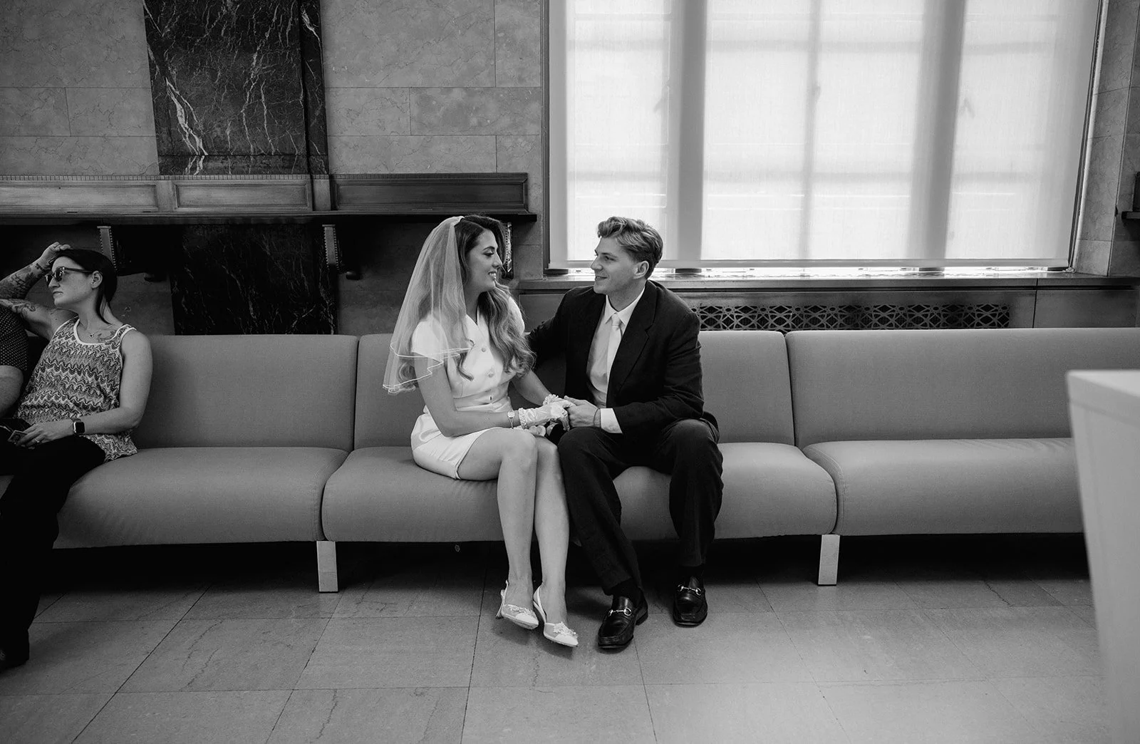 Newlyweds sitting together inside New York City Hall