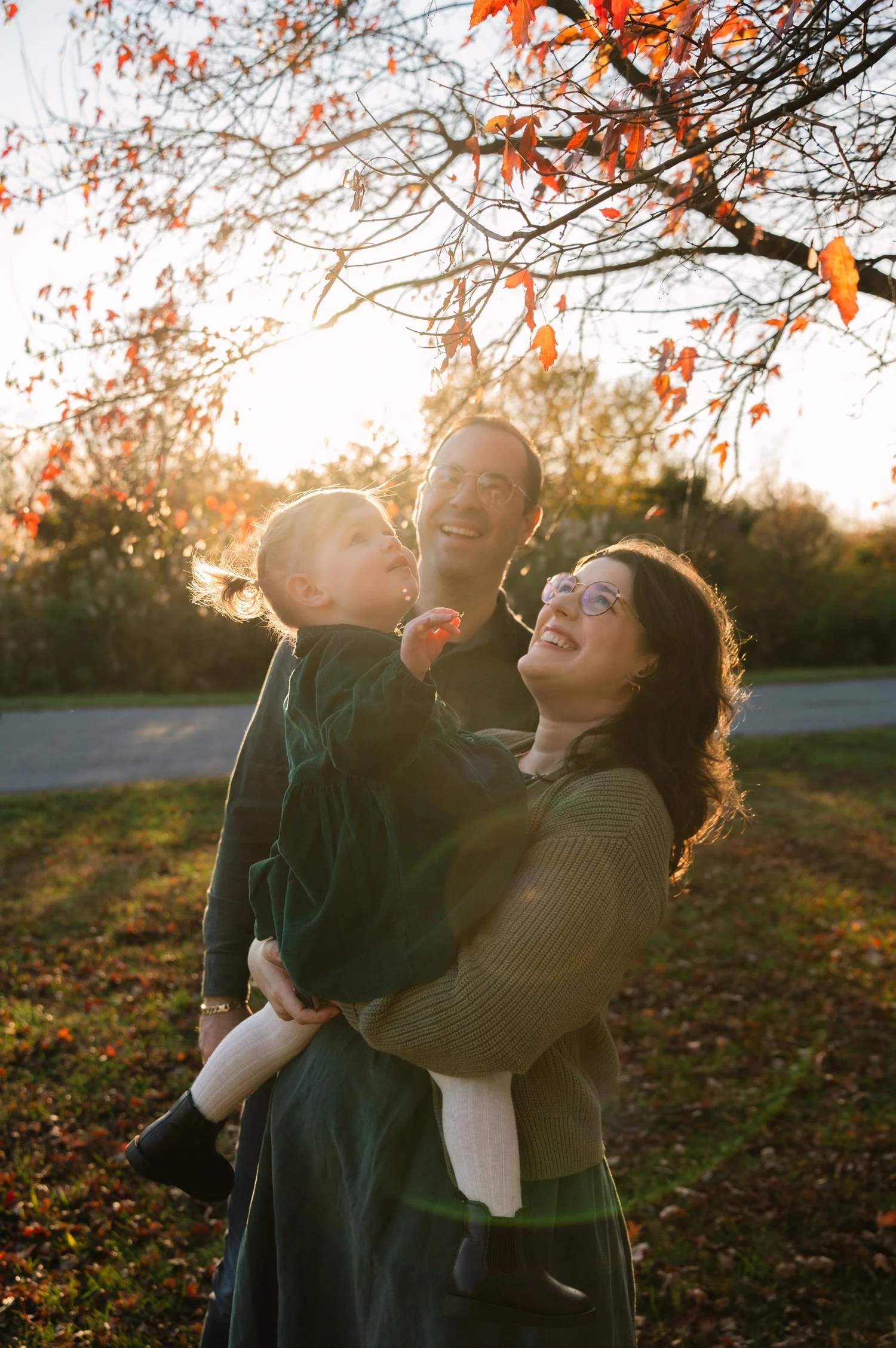 Family in golden fall light at Liberty State Park