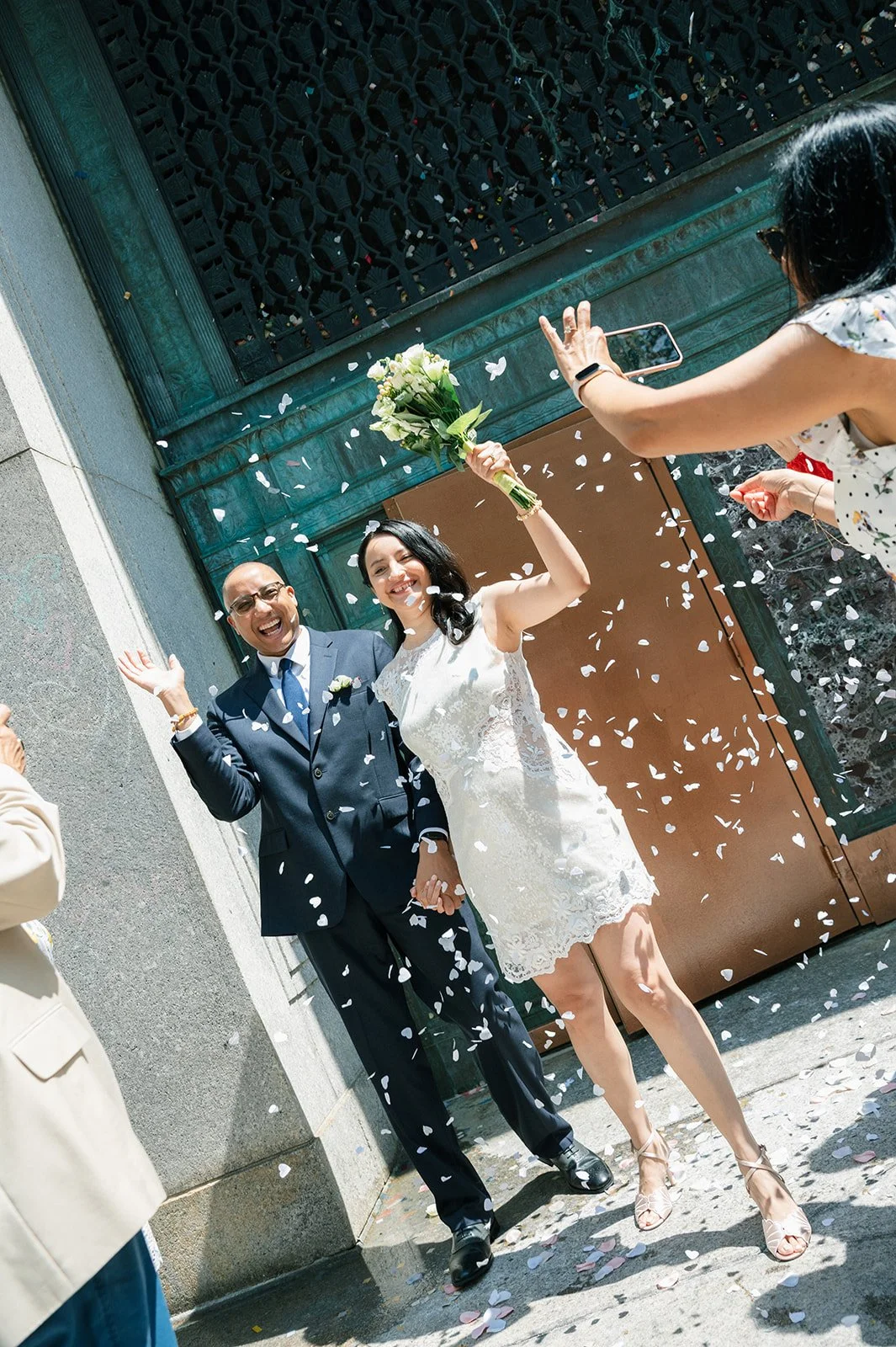 Newly married couple celebrating outside New York City Hall