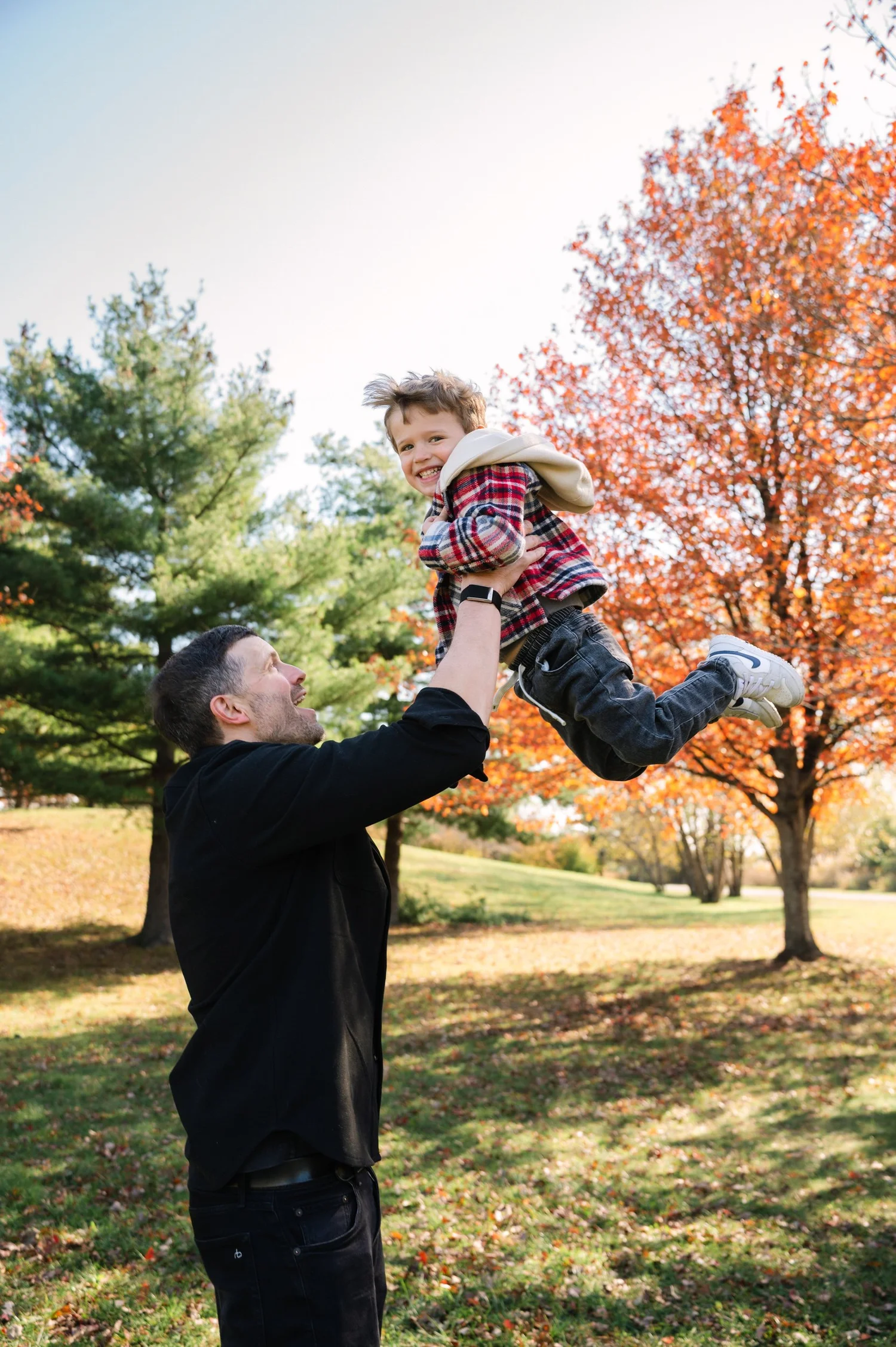 Father lifting his child during a fall family session