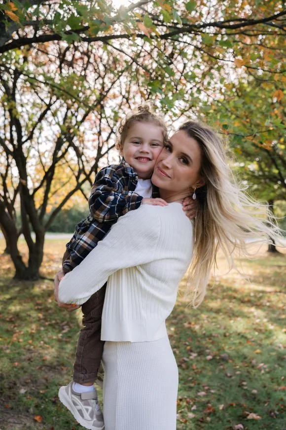 Mother holding her daughter during a fall family session