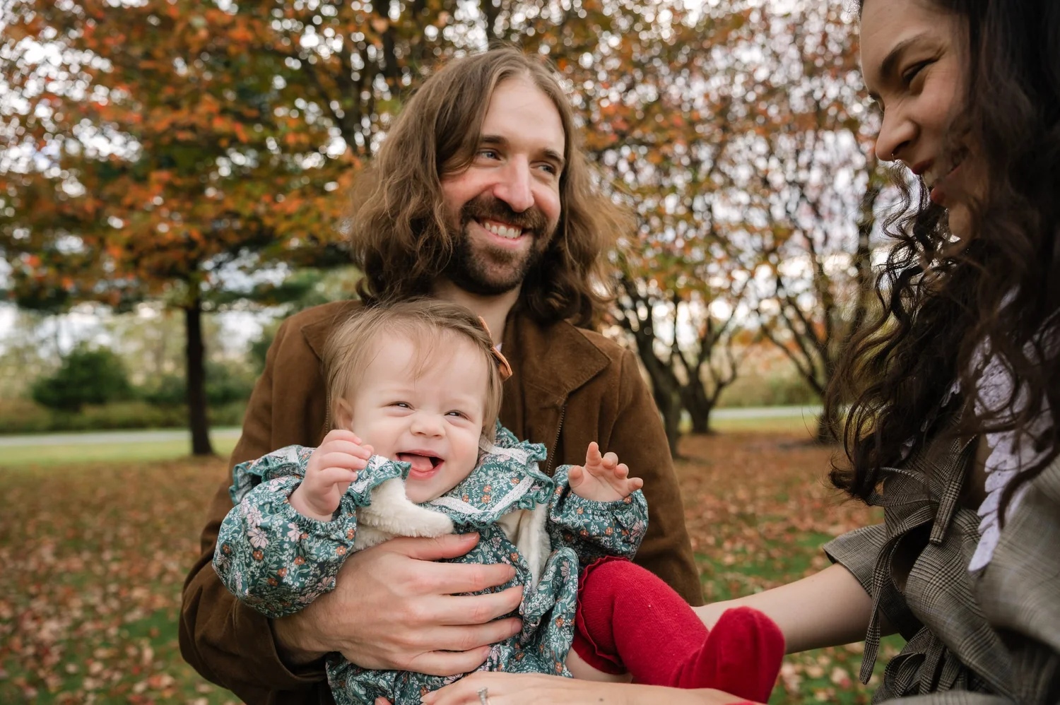 Family laughing together during a fall mini session
