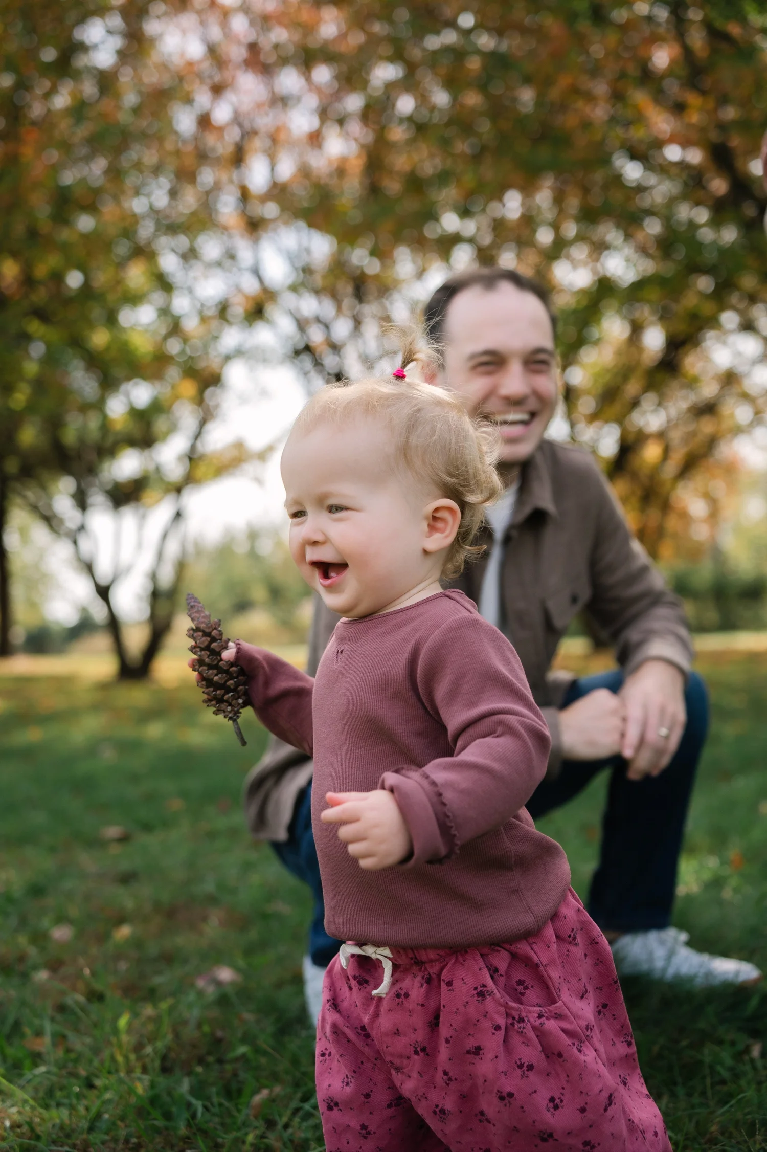 Child running and laughing during a fall family session