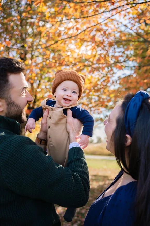 Parents playing with their baby during a fall family session