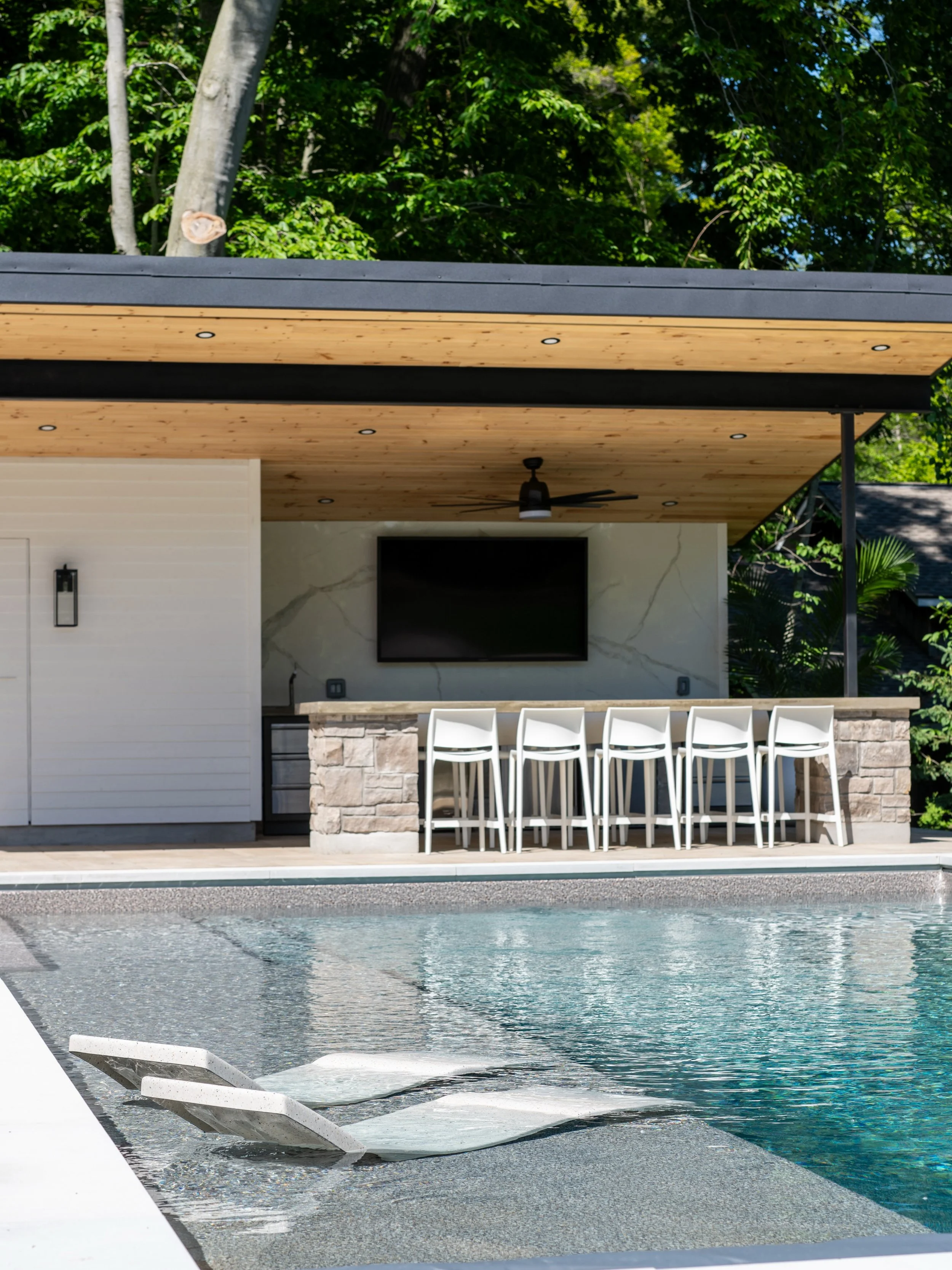 Why head into Grand Bend when the best bar might be right in your own backyard?

Designed for entertaining, this custom pavilion was built for unforgettable nights with family and friends. Concrete countertops are surrounded by generous seating, crea