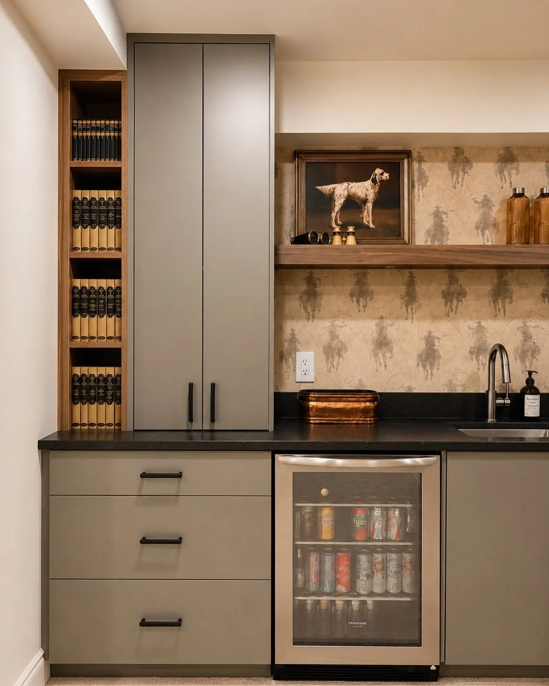 Custom bar with a twist.

Rather than going the traditional route with a tiled backsplash, we chose a playful cowboy sillouette wallpaper that gives this basement bar its personality. Dark honed countertops ground the design, while the warm wood shel