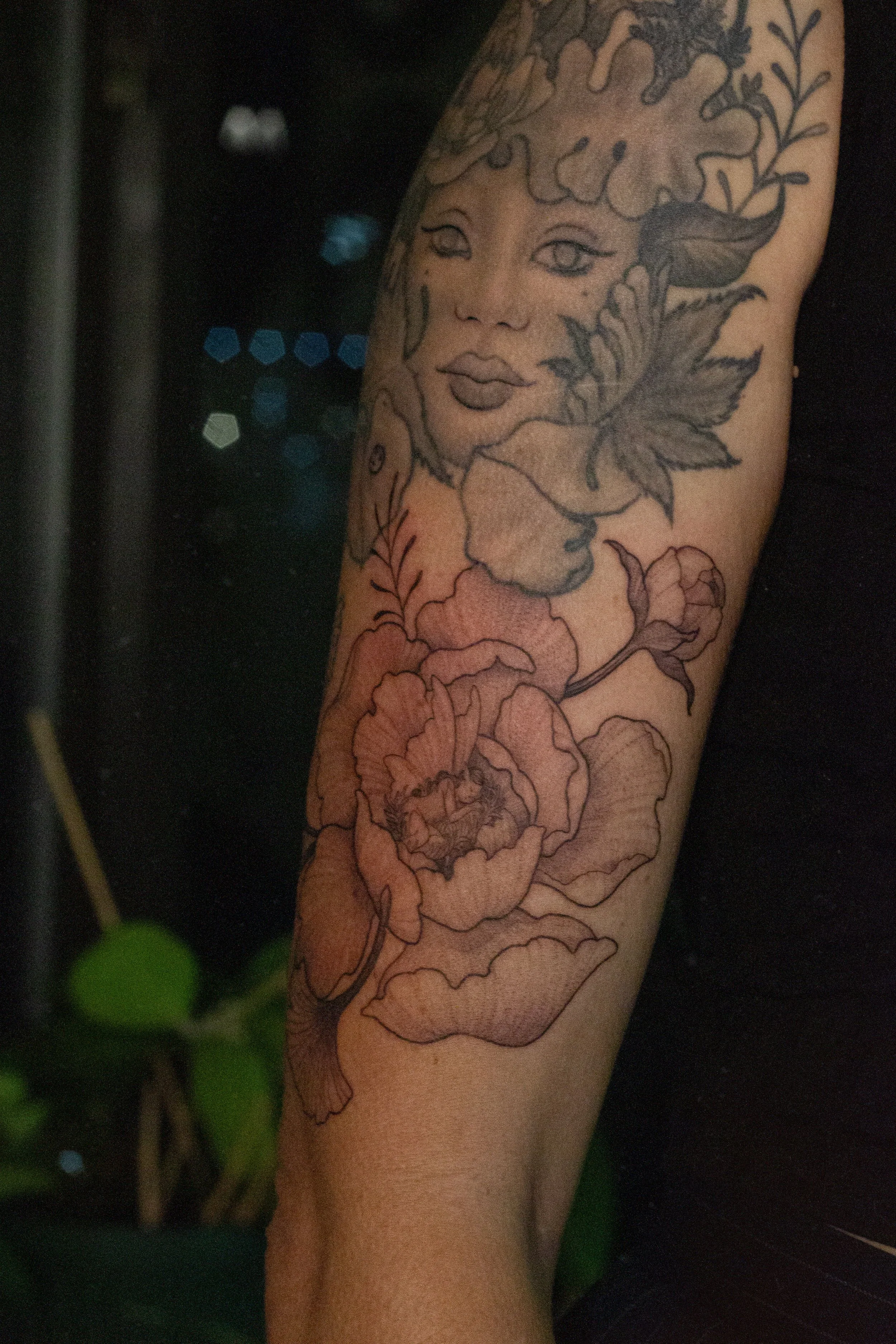 November 2025 · Freehand peony with sleeping fae underneath healed tattoo from 2021