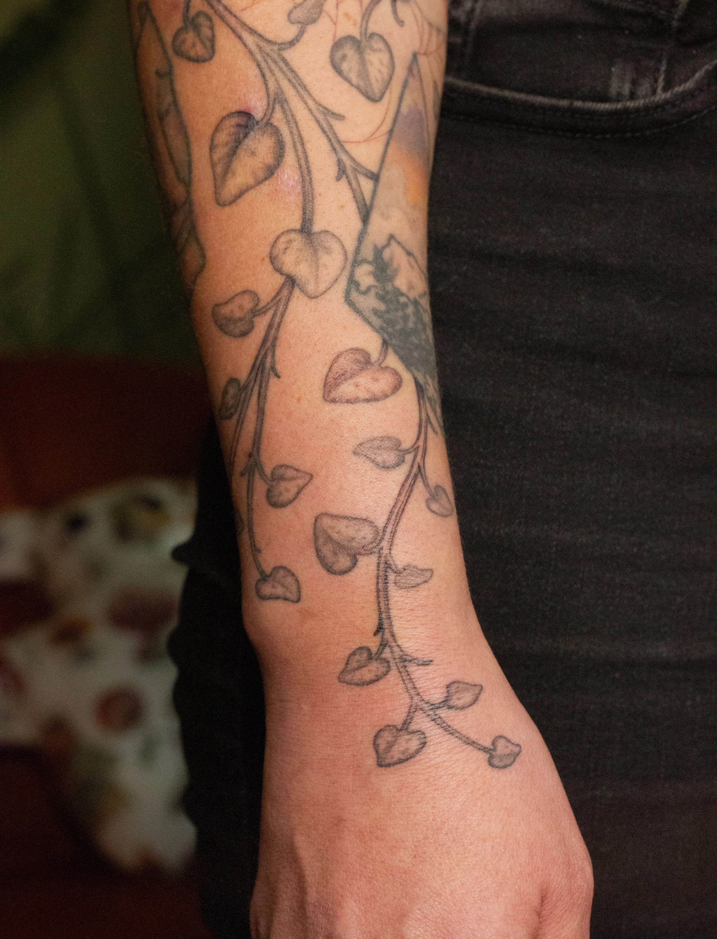 November 2025 · Freehand string of hearts in progress, wrist and hand healed with some touch-ups
