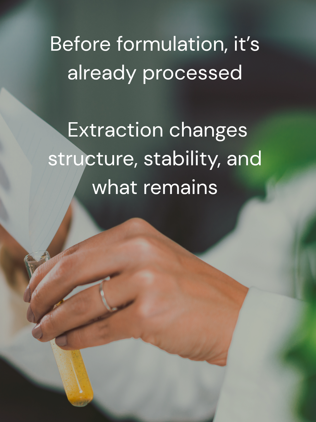 Dropper extracting liquid from plant material in minimal lab setting, illustrating ingredient processing