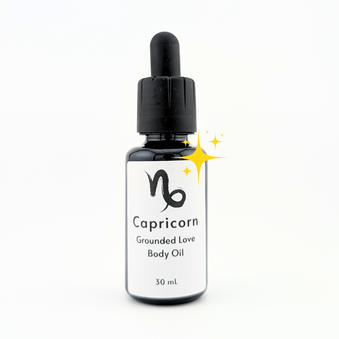 Black glass bottle of Capricorn Grounded Love Star Sign body oil with dropper cap against white background.png