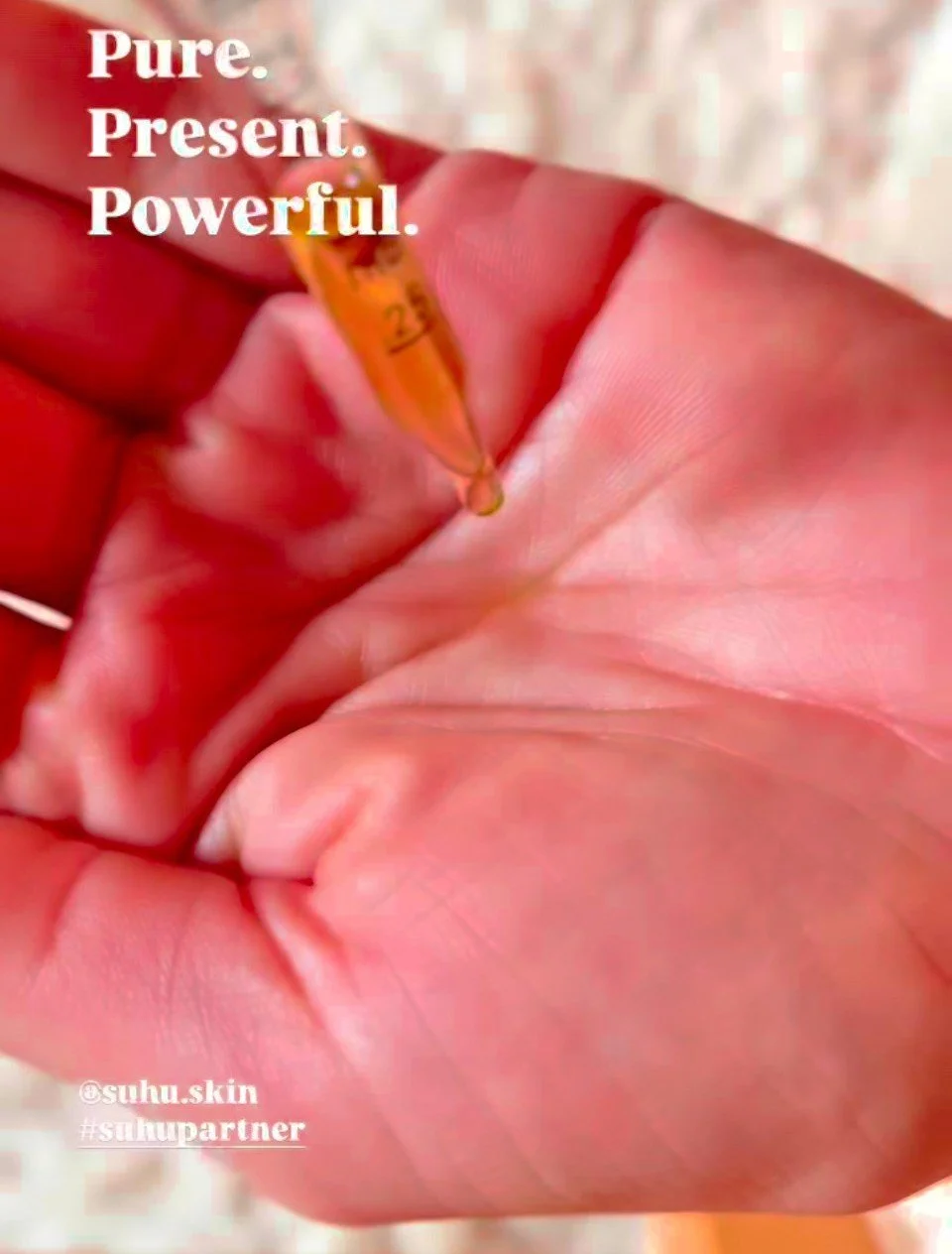 Close-up of a hand holding a small vial or test tube with a pink liquid inside. Overlaid text reads 'Pure. Present. Powerful.'.