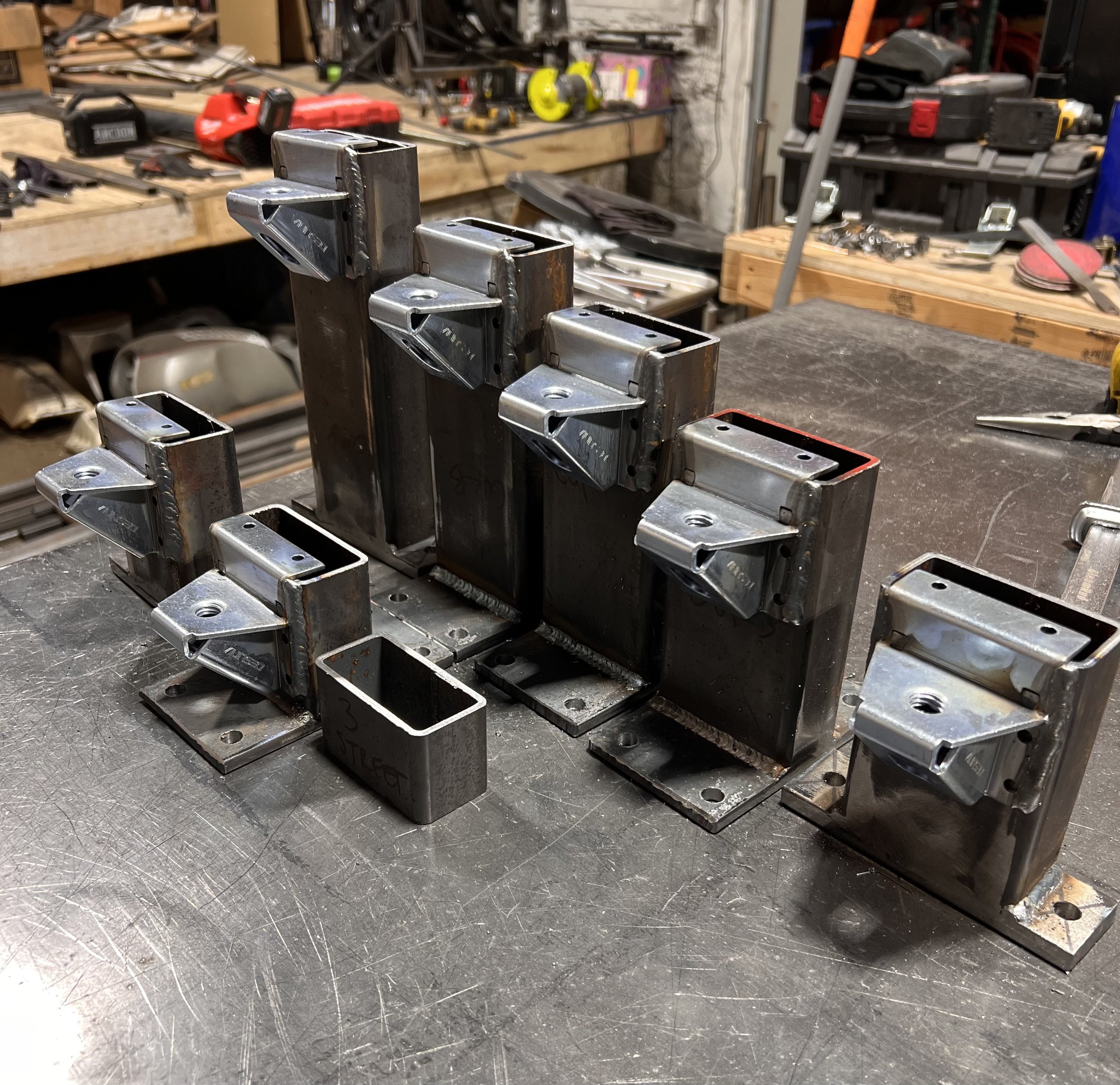Custom removable steel leg assemblies fabricated to level and connect the modular Love & Hominy parklet in Hood River, Oregon.