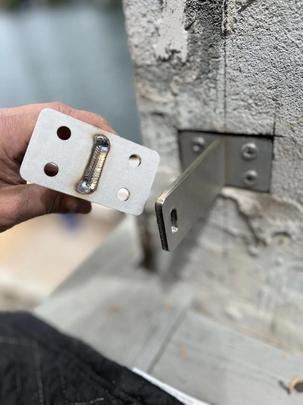 Custom-fabricated architectural metal connection being fit on site for The York waterfront project in Lake Oswego, Oregon, translating project-specific design details into the final installation.