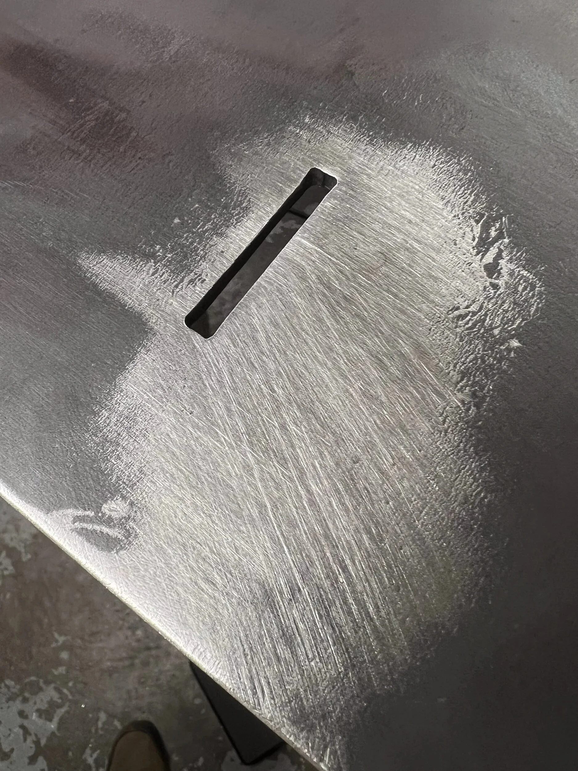 Tab-and-slot joint on laser-cut, press-brake-formed steel parts that interlock like puzzle pieces — designed and fabricated by de stijl FORMS in Hood River, Oregon.