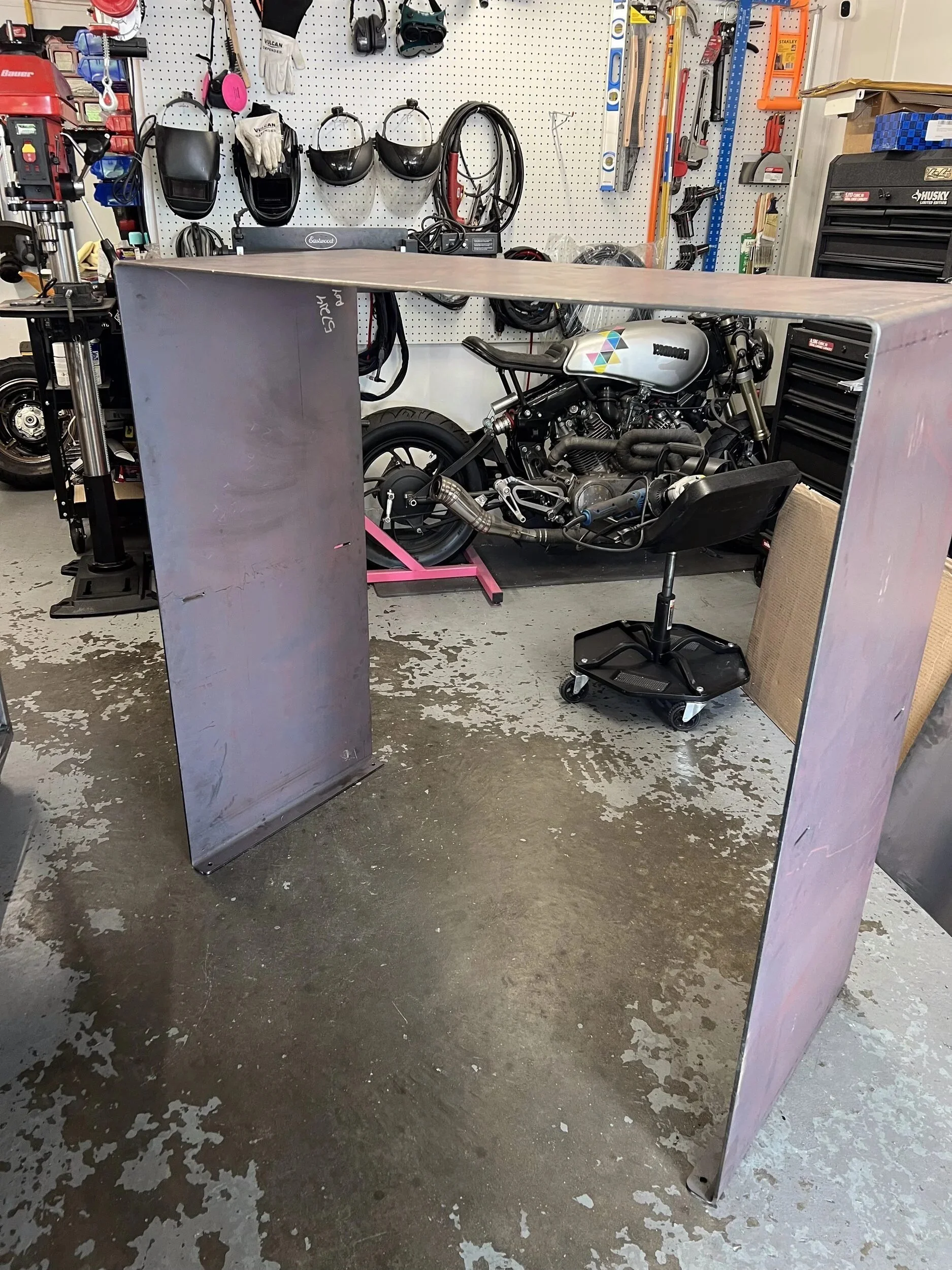 Raw steel firewood storage box standing in the fabrication shop before its satin black finish — designed and fabricated by de stijl FORMS in Hood River, Oregon.