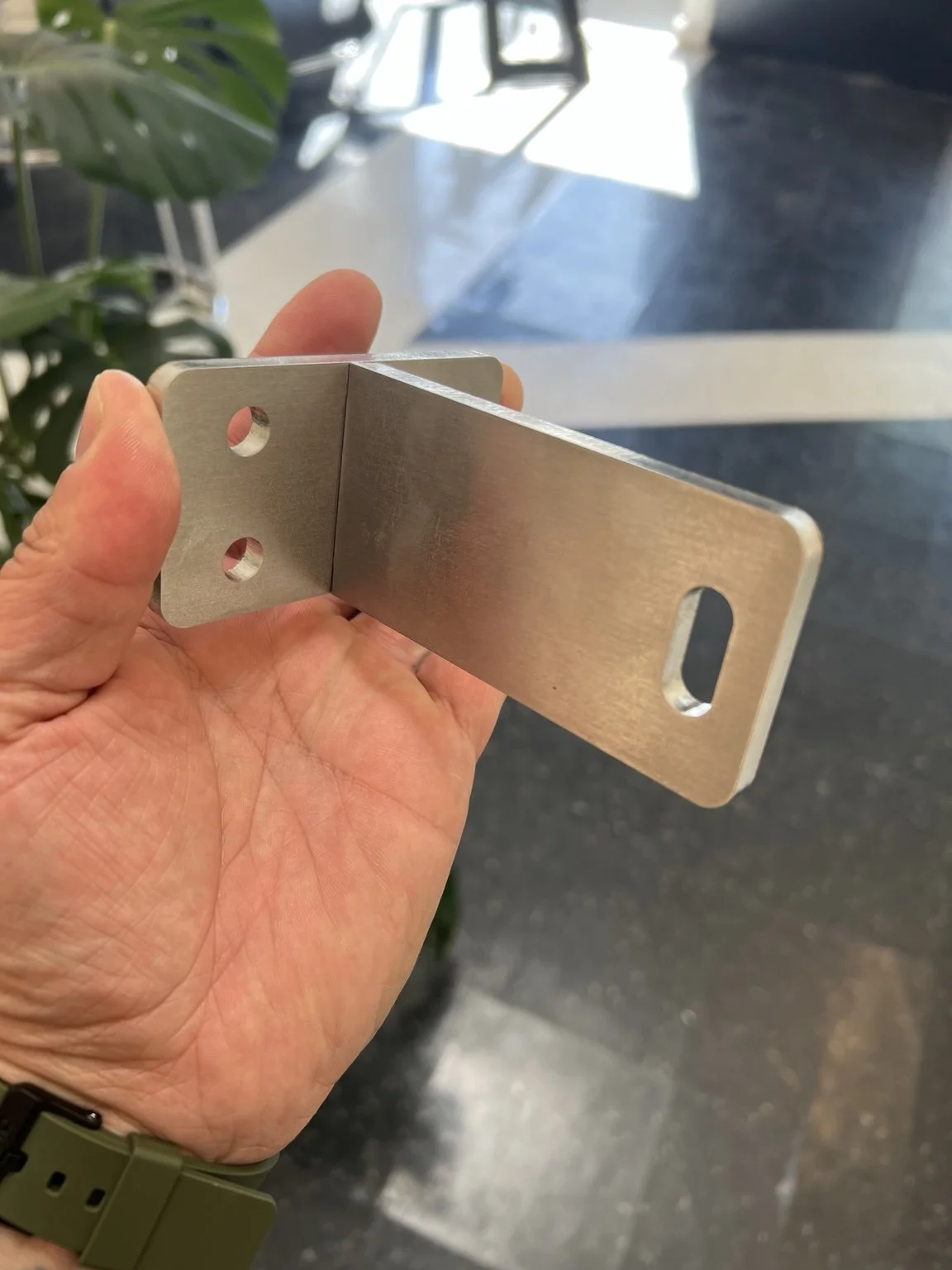 Custom stainless steel mounting bracket fabricated from the project-specific Fusion 360 design for The York railing system in Lake Oswego, Oregon.