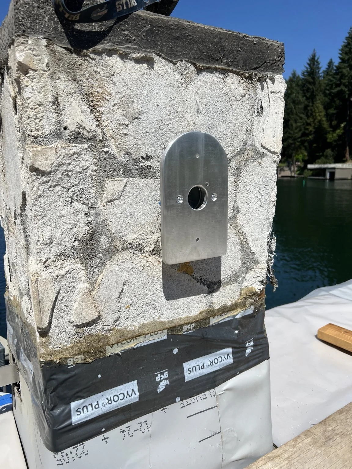 Custom aluminum mounting plate designed and fabricated for a Schoolhouse Electric exterior sconce at The York in Lake Oswego, Oregon, adapting the fixture to the project’s existing architectural and masonry conditions.