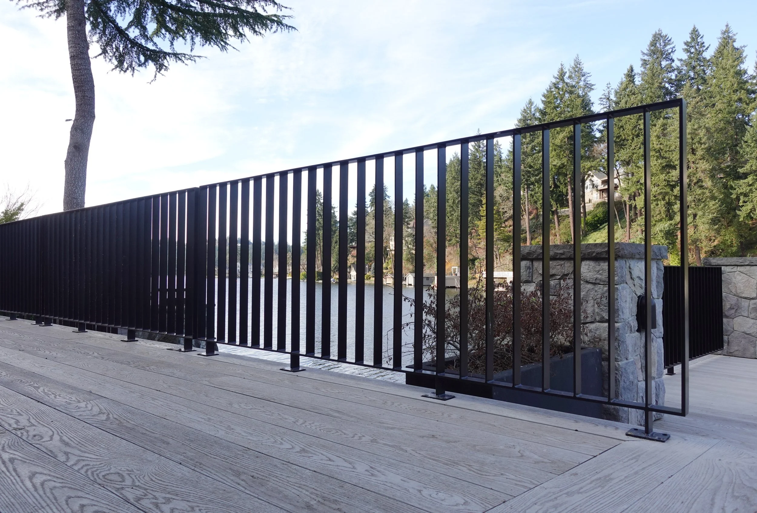 Custom black steel railing overlooking the waterfront at The York residence in Lake Oswego, Oregon, designed and fabricated by de stijl FORMS.