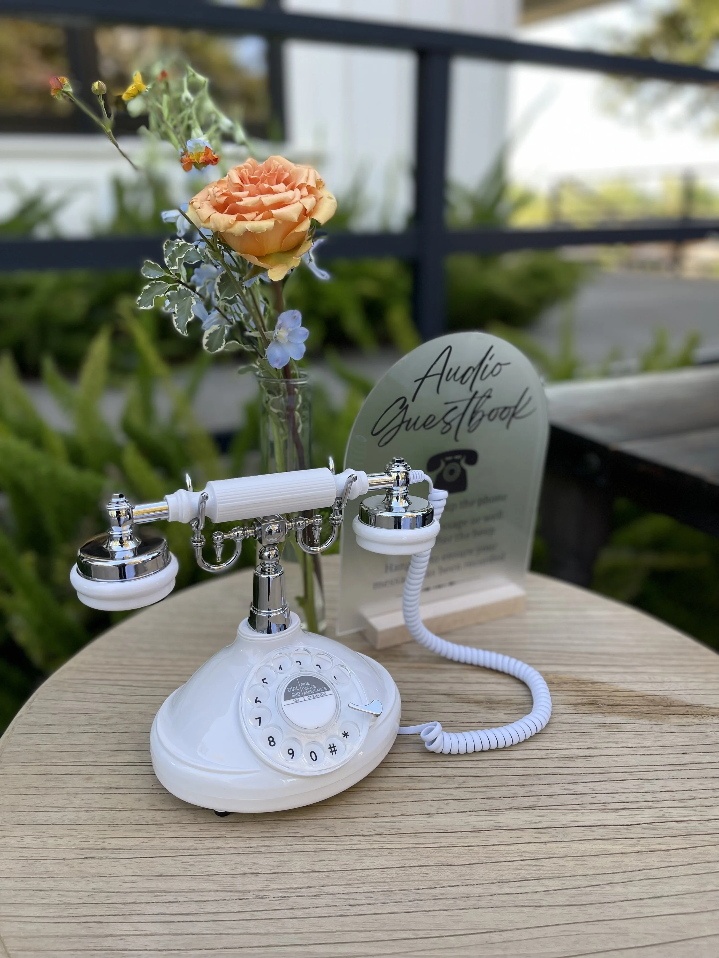Creative Corner Rentals white vintage-style Audio Guest Book telephone displayed with flowers at a wedding reception in Sacramento